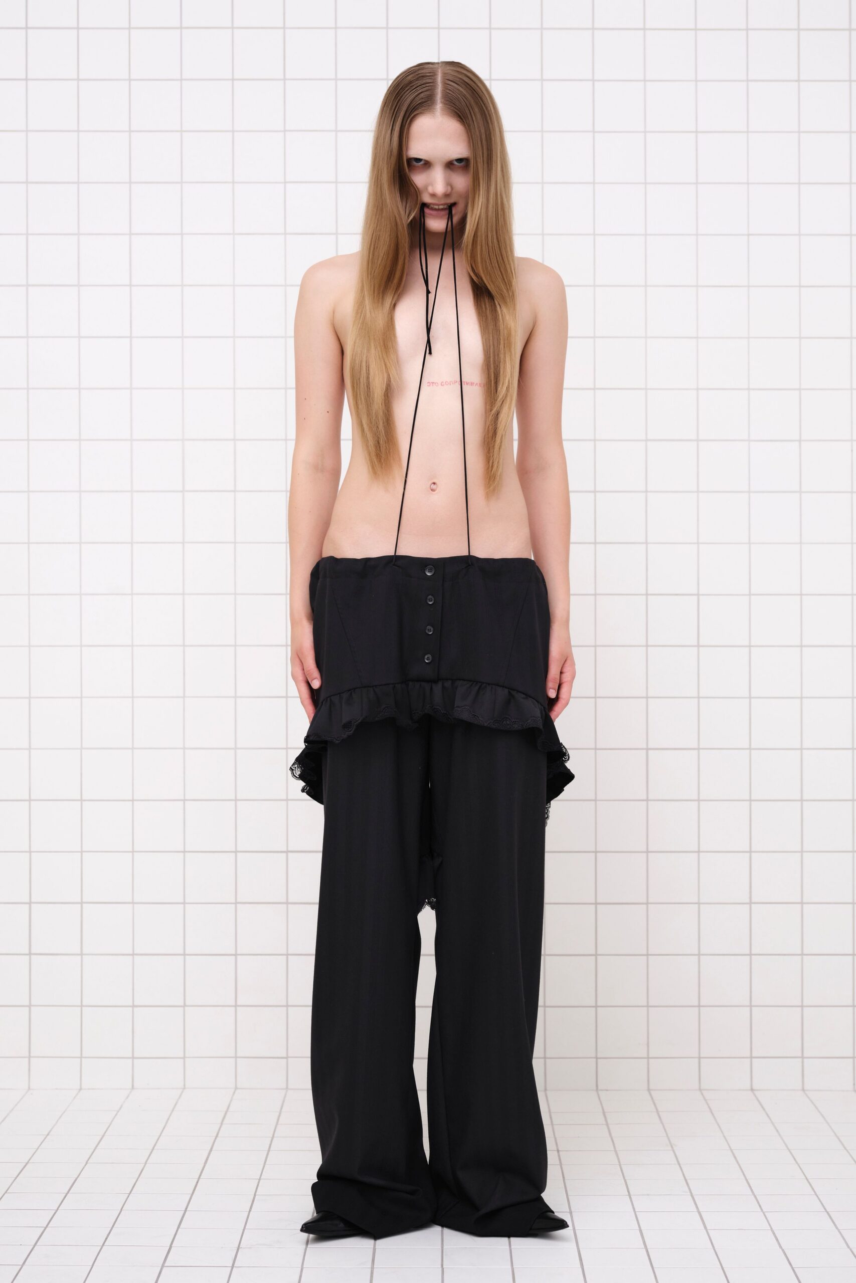 black fitted top with ruffles and relaxed pants
