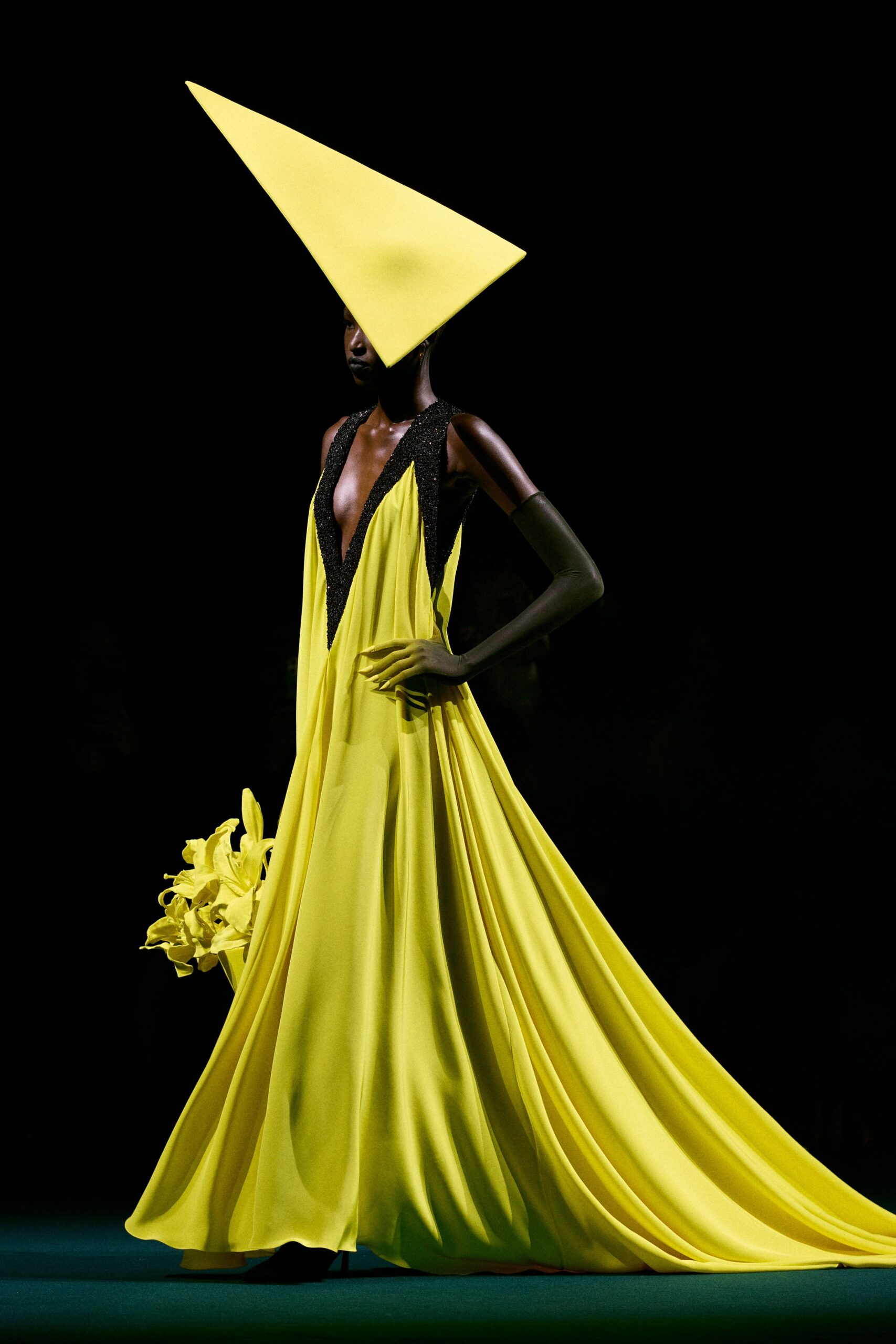 yellow silk sleeveless gown with structured hat