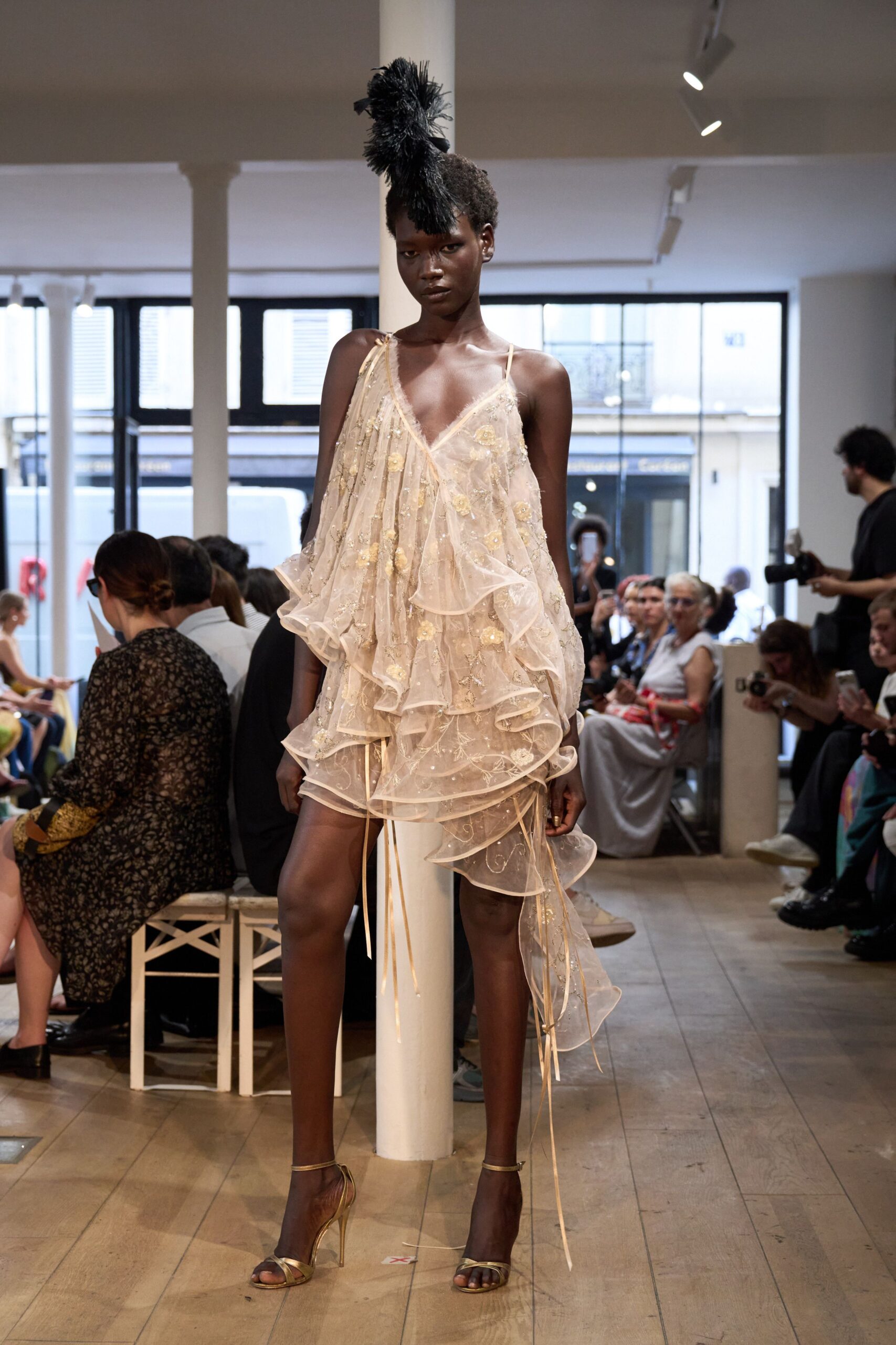 beige ruffled mini dress with gold shoes
