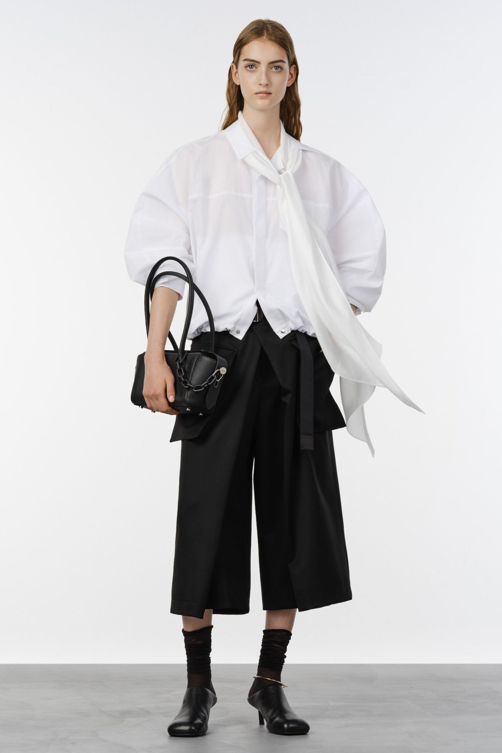 white relaxed shirt with black pants