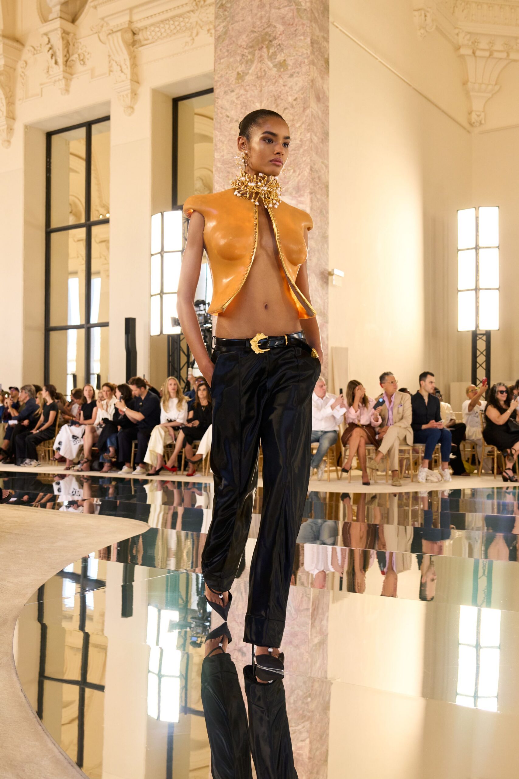 orange leather sleeveless top with black pants