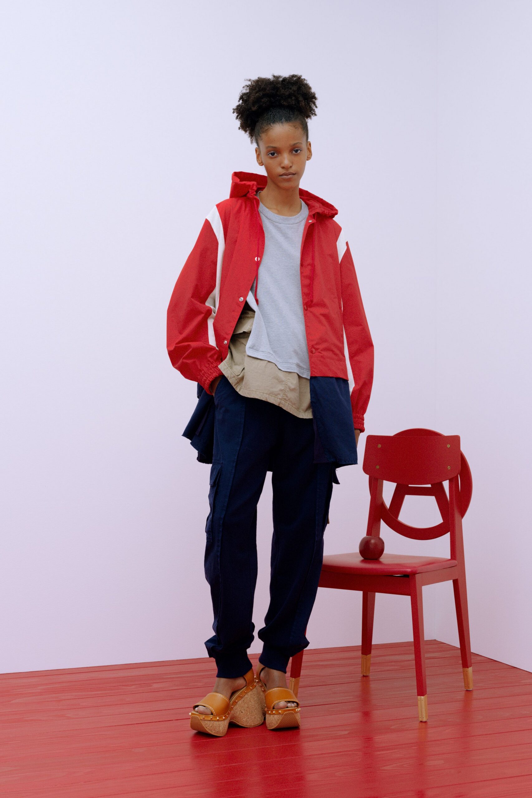 red jacket gray t-shirt navy pants brown shoes