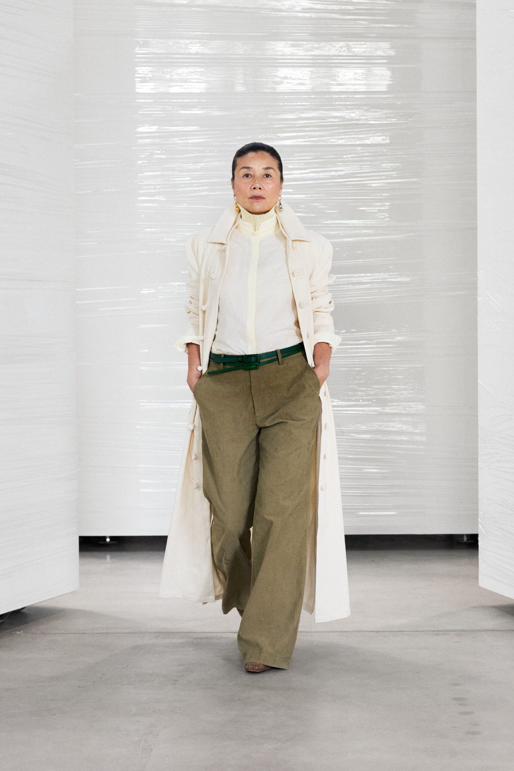 white trench coat with green pants