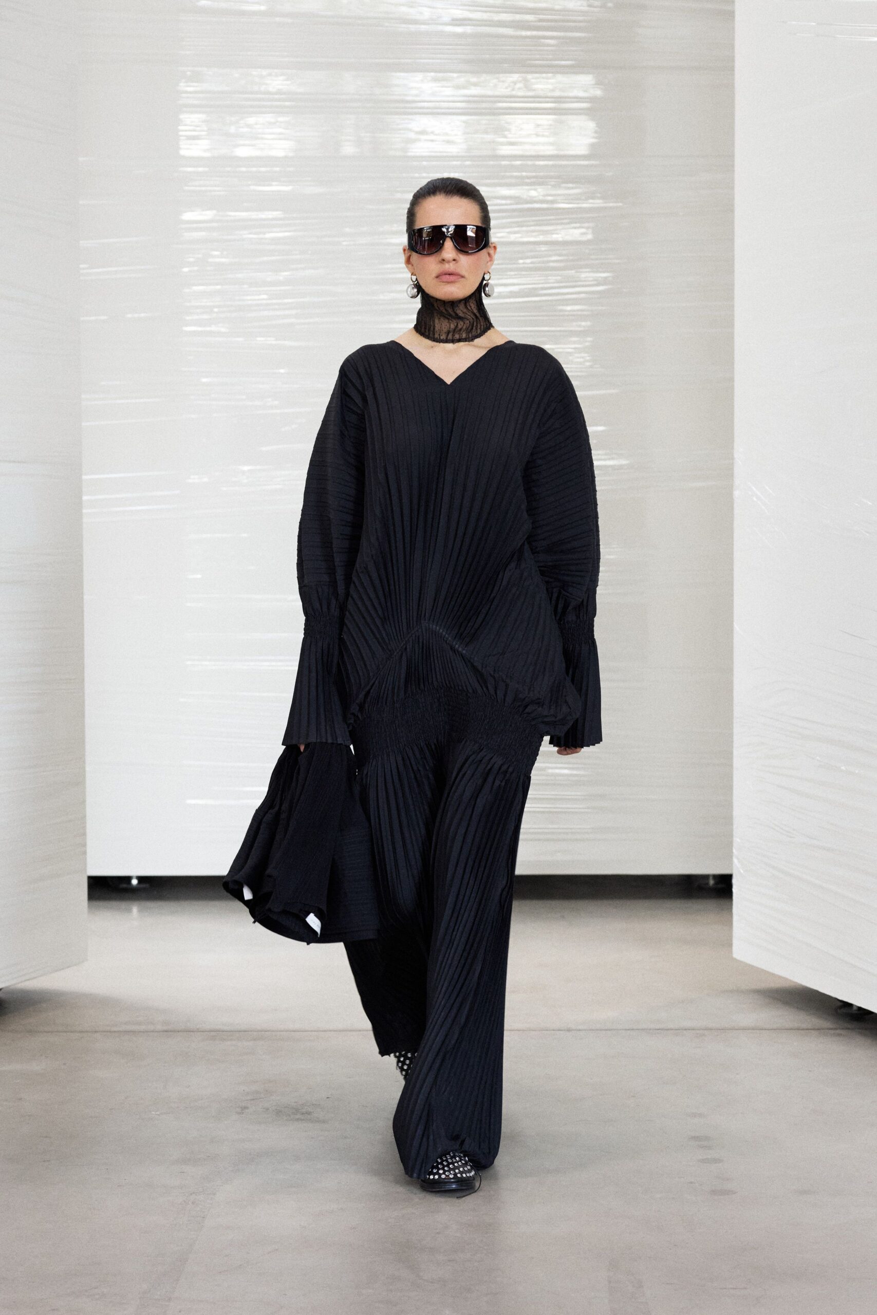black pleated maxi dress with sunglasses