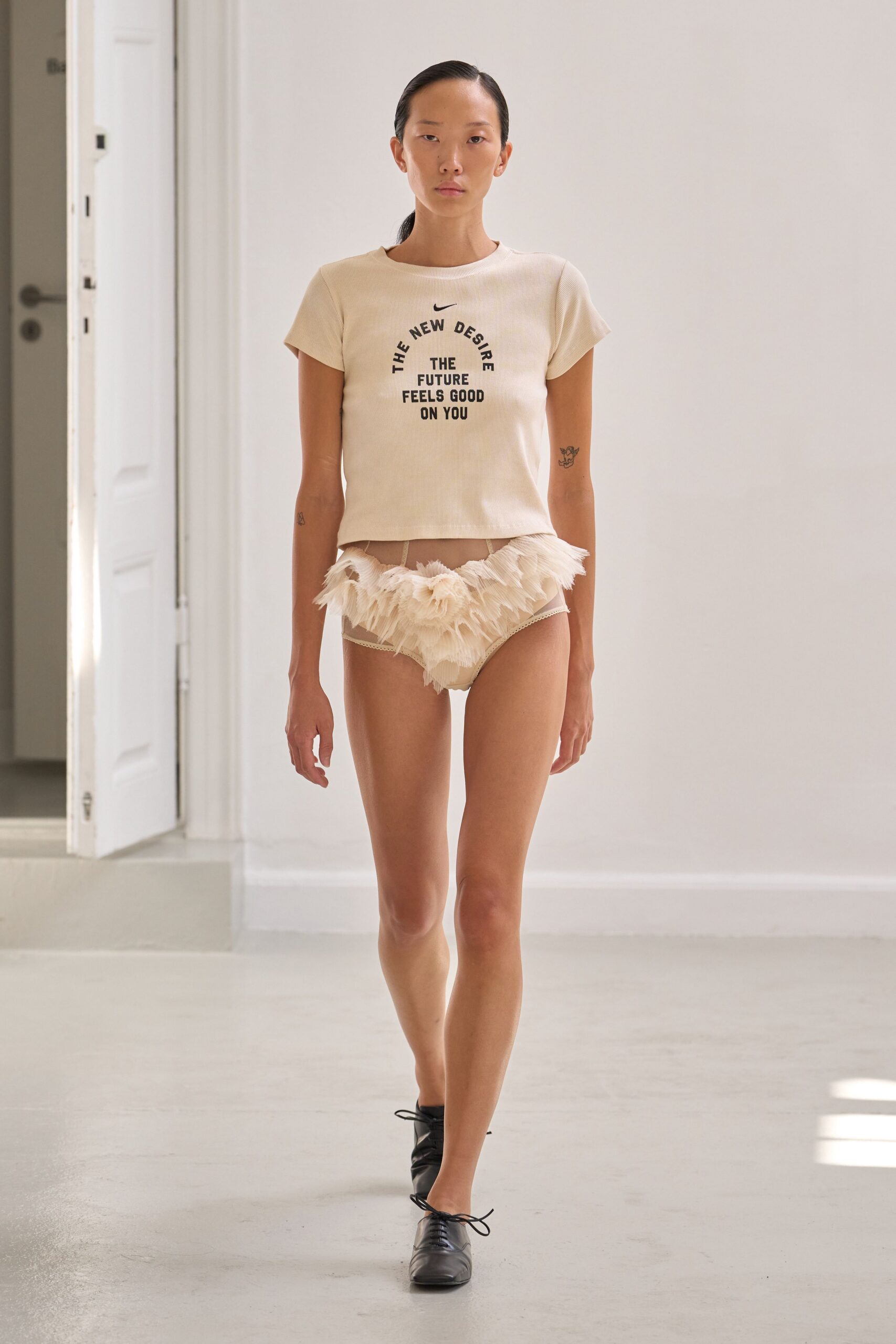 beige printed top with white ruffled shorts