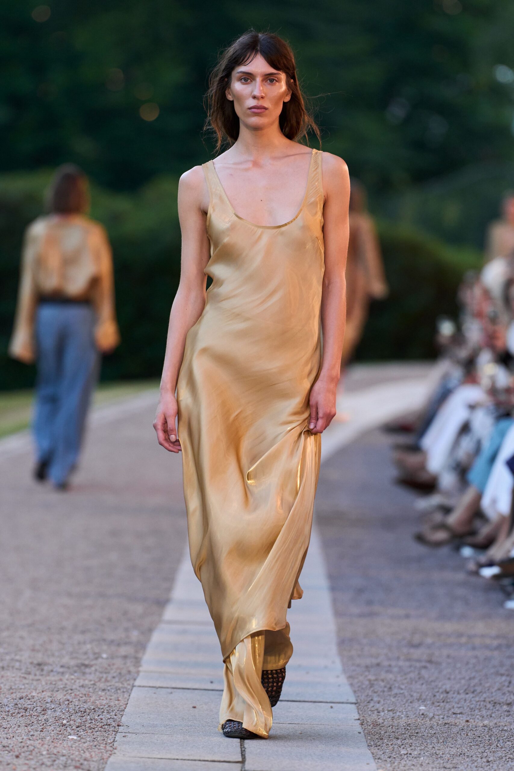 gold silk sleeveless v-neck fitted flowing shiny gown