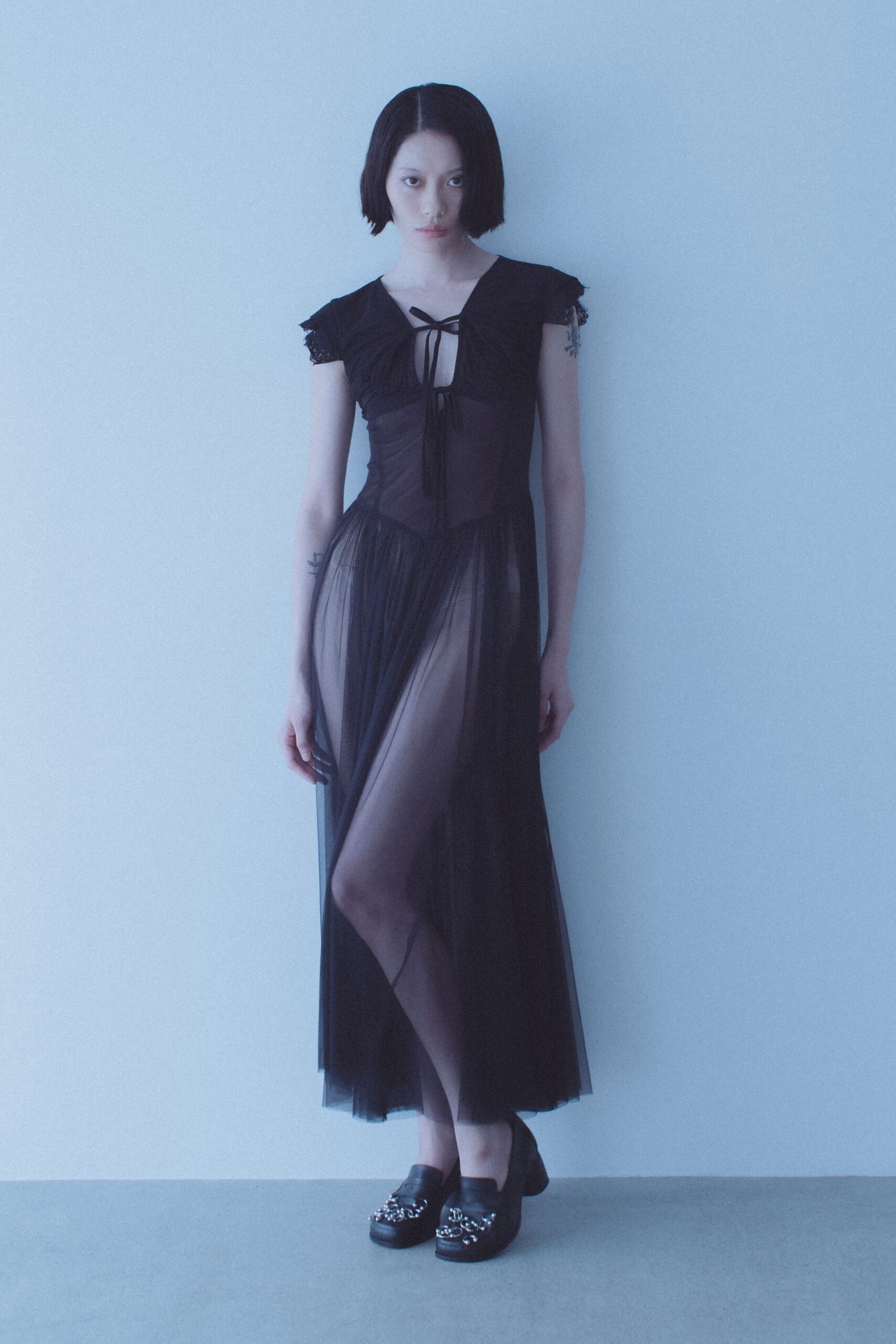 black sheer tulle gown with embellished shoes