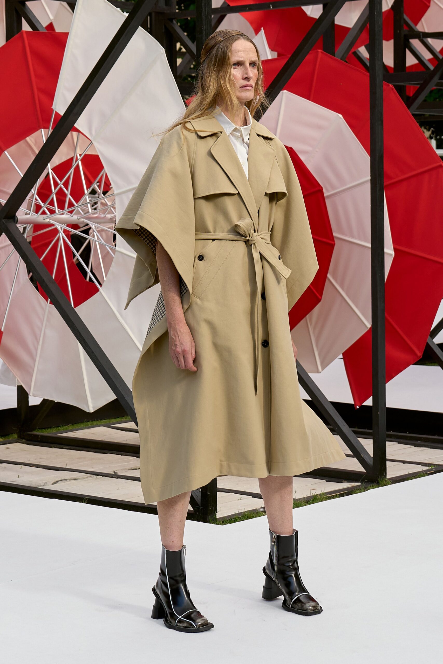 beige relaxed trench coat with black boots