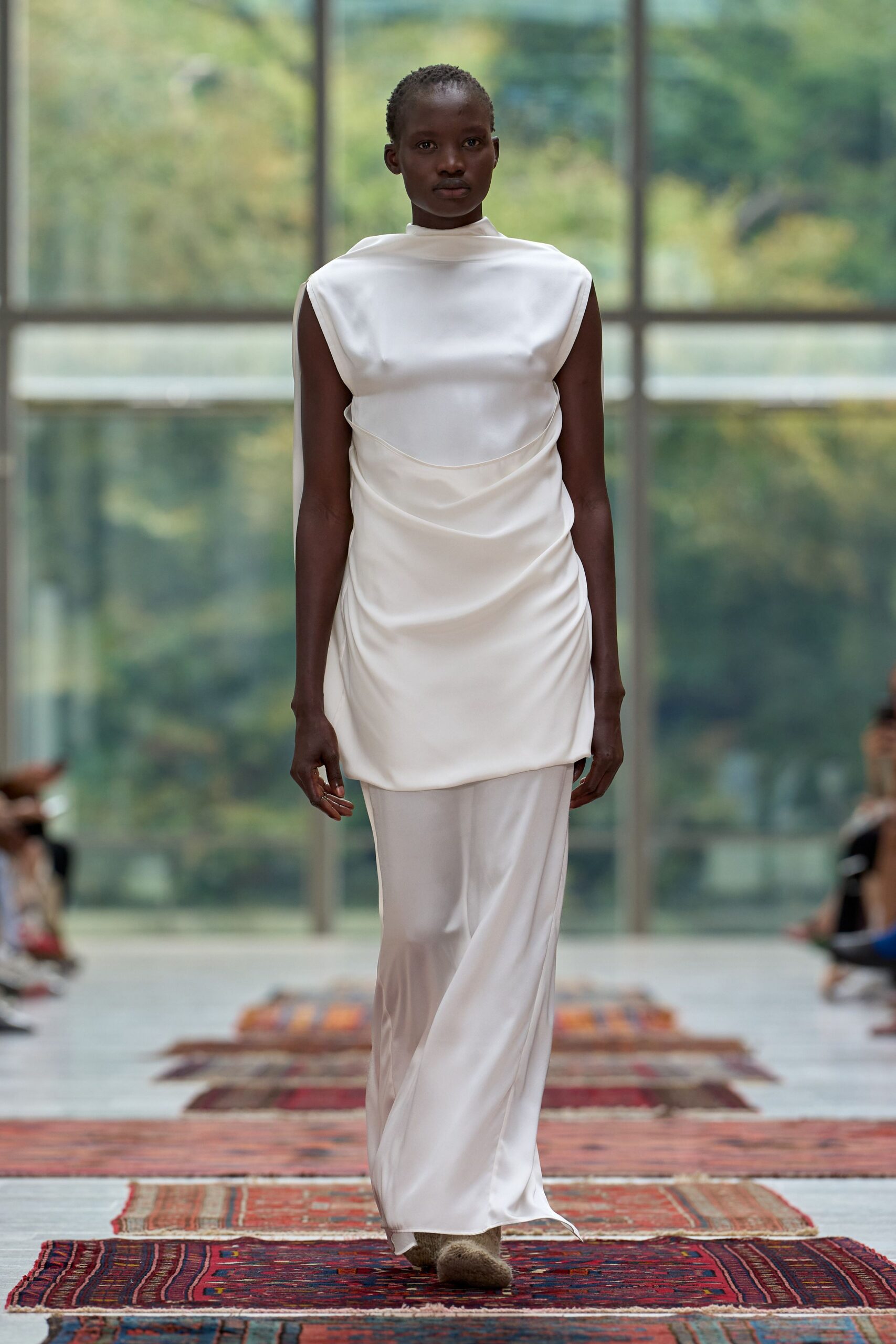 ivory satin sleeveless high-neck draped flowing shiny gown