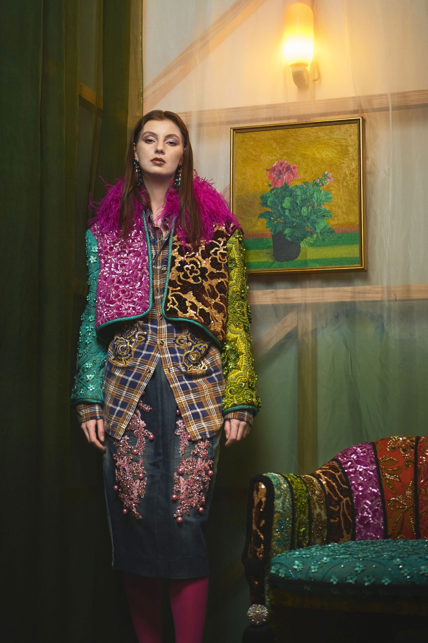 Magenta feather-collared bolero patched in sequined brocade, over a tan plaid shirt with blue beaded appliqué at the pockets. Dark denim pencil skirt traced with pink pearl embroidery, fuchsia tights. Waiting in a lamp-lit boarding house parlour.