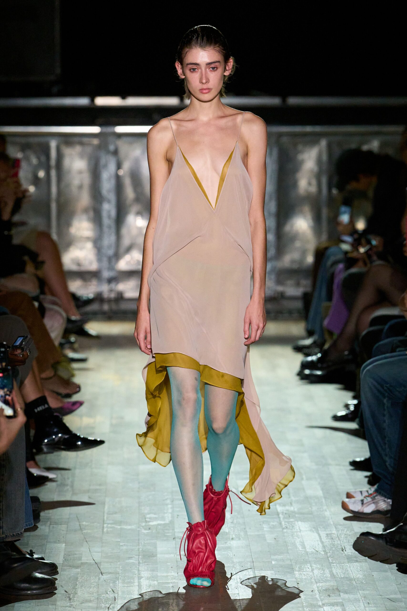 Blush chiffon slip dress with a plunging V and chartreuse underlayer. Powder-blue sheer tights. Fuchsia leather ankle boots ruched tight with loose drawstrings. Crossing a gym floor after midnight, still damp from the mop.