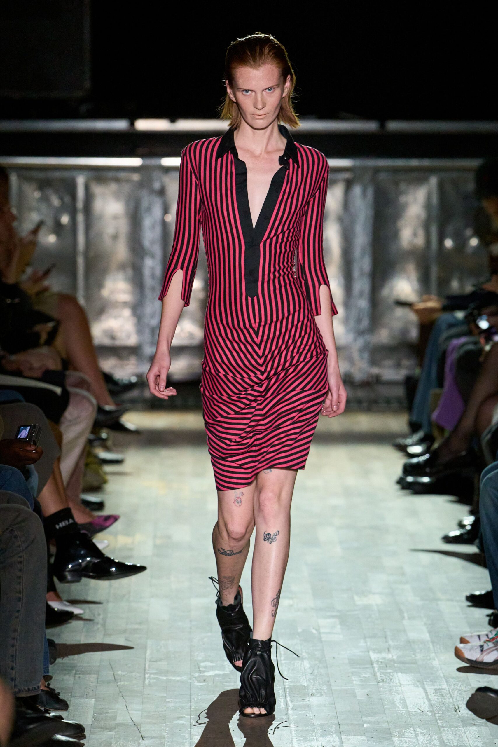 Hot-pink and black striped knit dress, plunged black placket and ruched hip. Black gathered leather bootie sandals, lace ends trailing on the floor. For ducking out of a basement gig while the street is still wet.