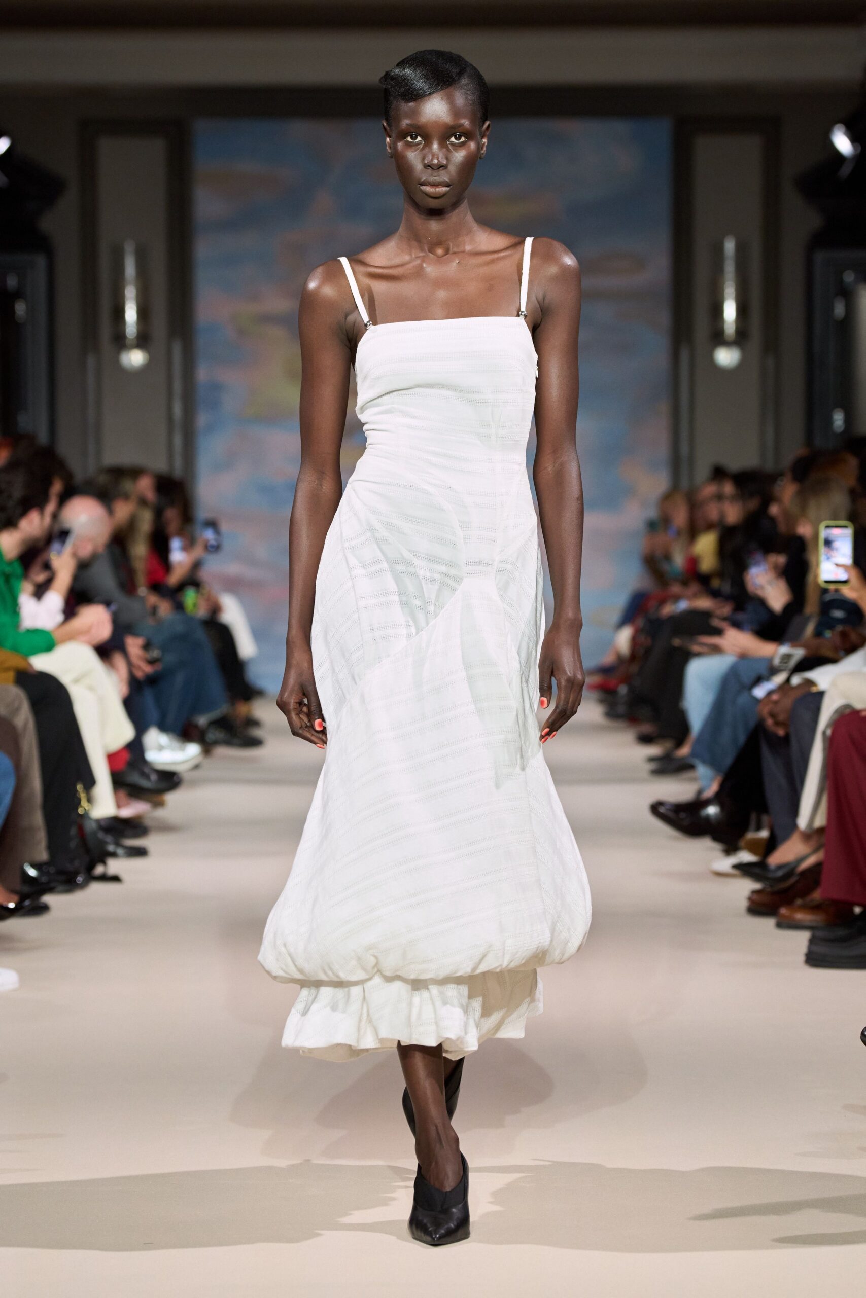 Chalk white slip dress in sheer horizontal stripes, hem puffed into a bubble over a ruffle. Black pointed pumps. Walking back from a courthouse wedding with your shoes in your hand.