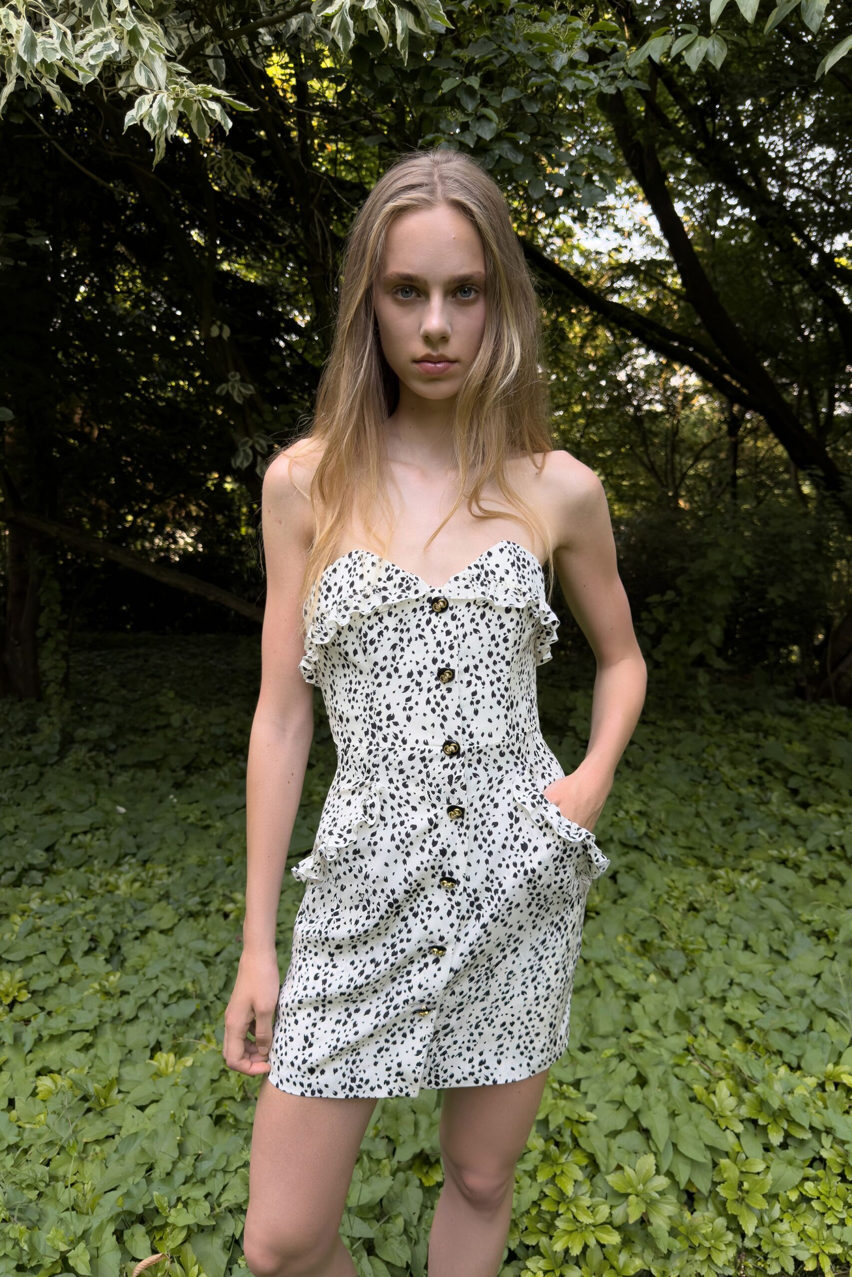 Ivory mini scattered with black flecks, ruffled sweetheart edge and horn-look buttons. Ruffled hip pockets jutting out from the fitted waist seam. Cutting through an overgrown garden before anyone notices you slipped out.