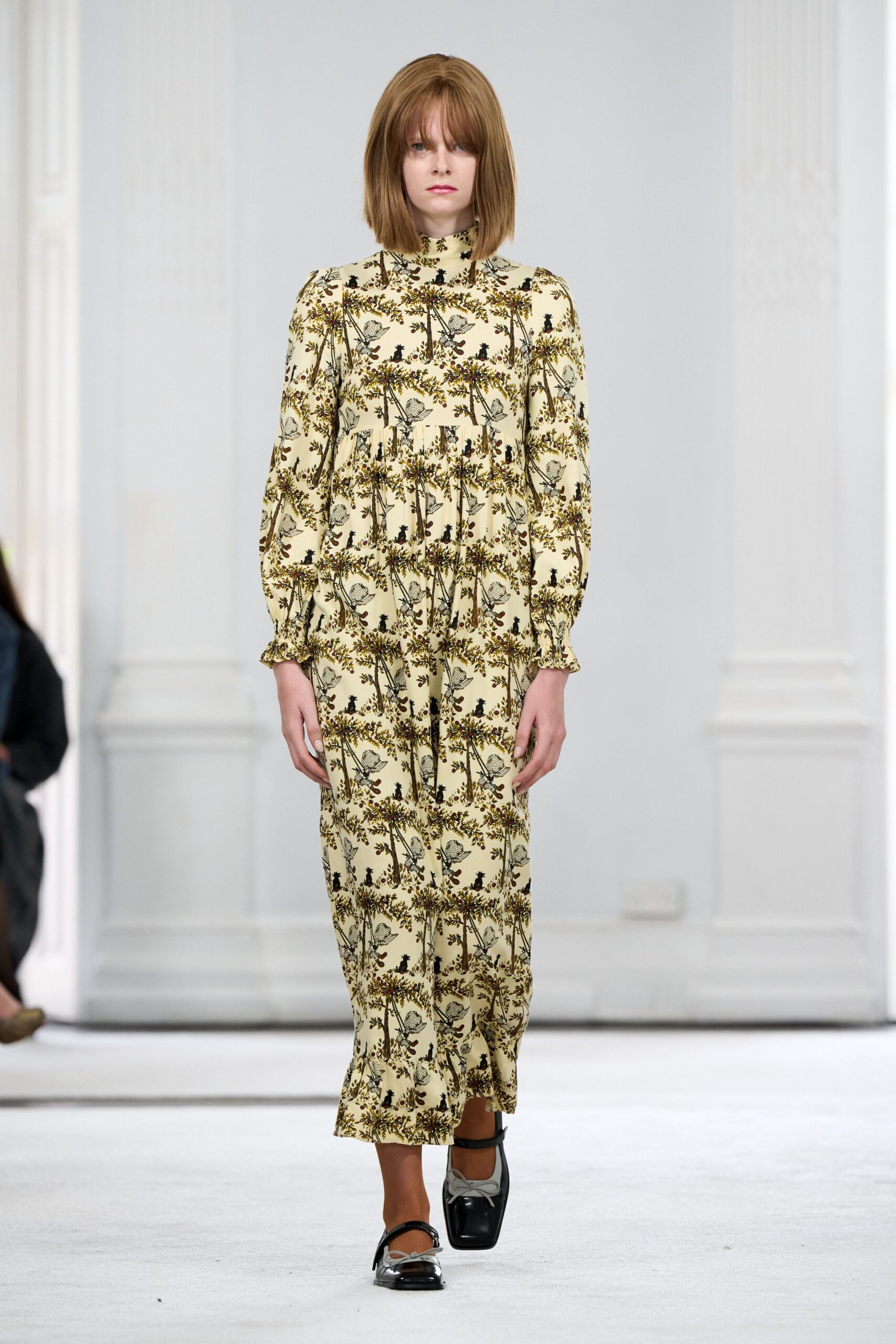 Cream midi dress in a bird-and-garland print, gathered below the bust. Black square-toe Mary Janes with pale grey bow ties. Sheer cinnamon tights. Sunday house tour, parquet floors creaking under every careful step.