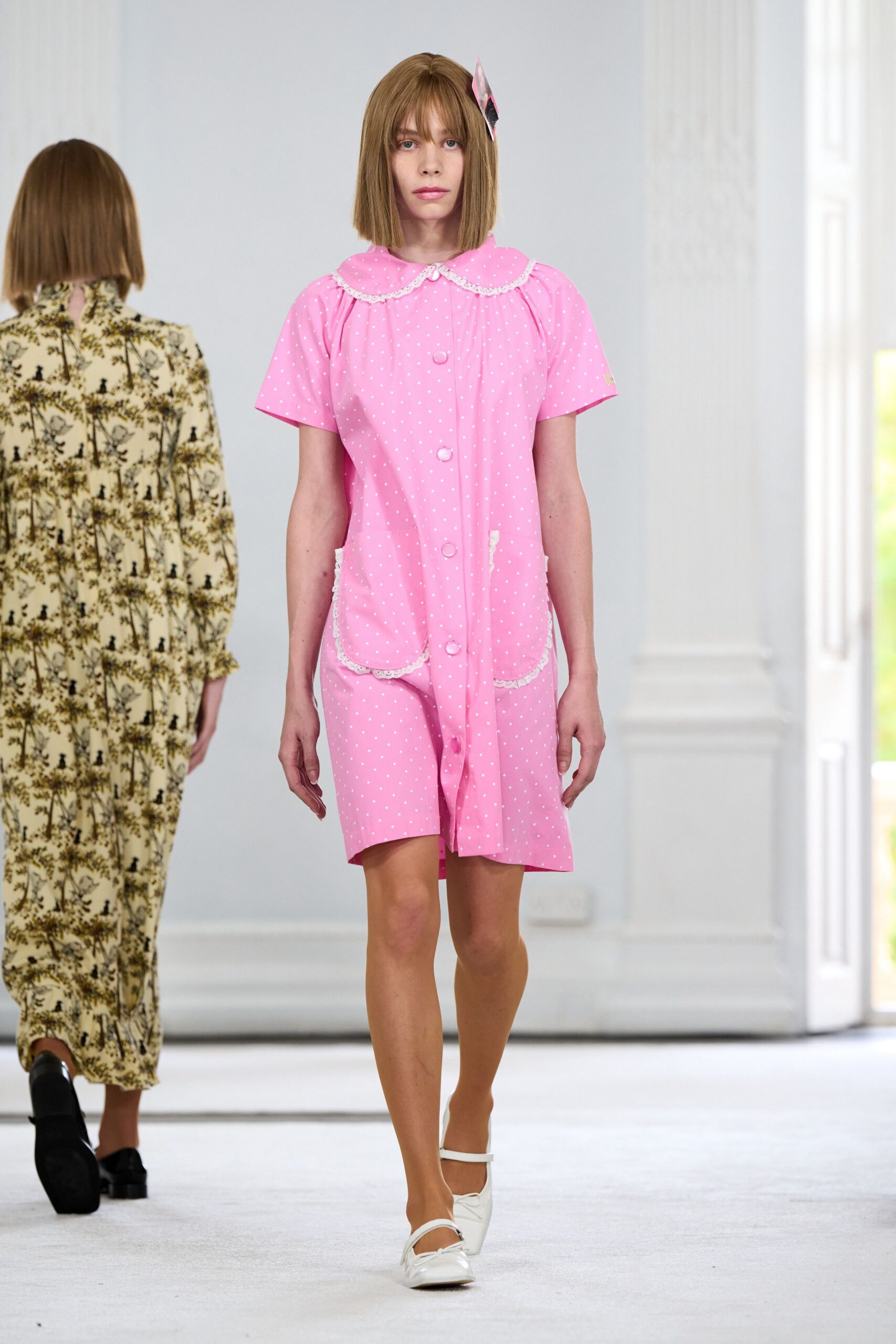 Bubblegum pink romper in tiny white polka dots, scalloped lace Peter Pan collar. Pink diamond clip at the temple. White Mary Jane flats with squared toes. For answering the door at noon when the babysitter still hasn't left.