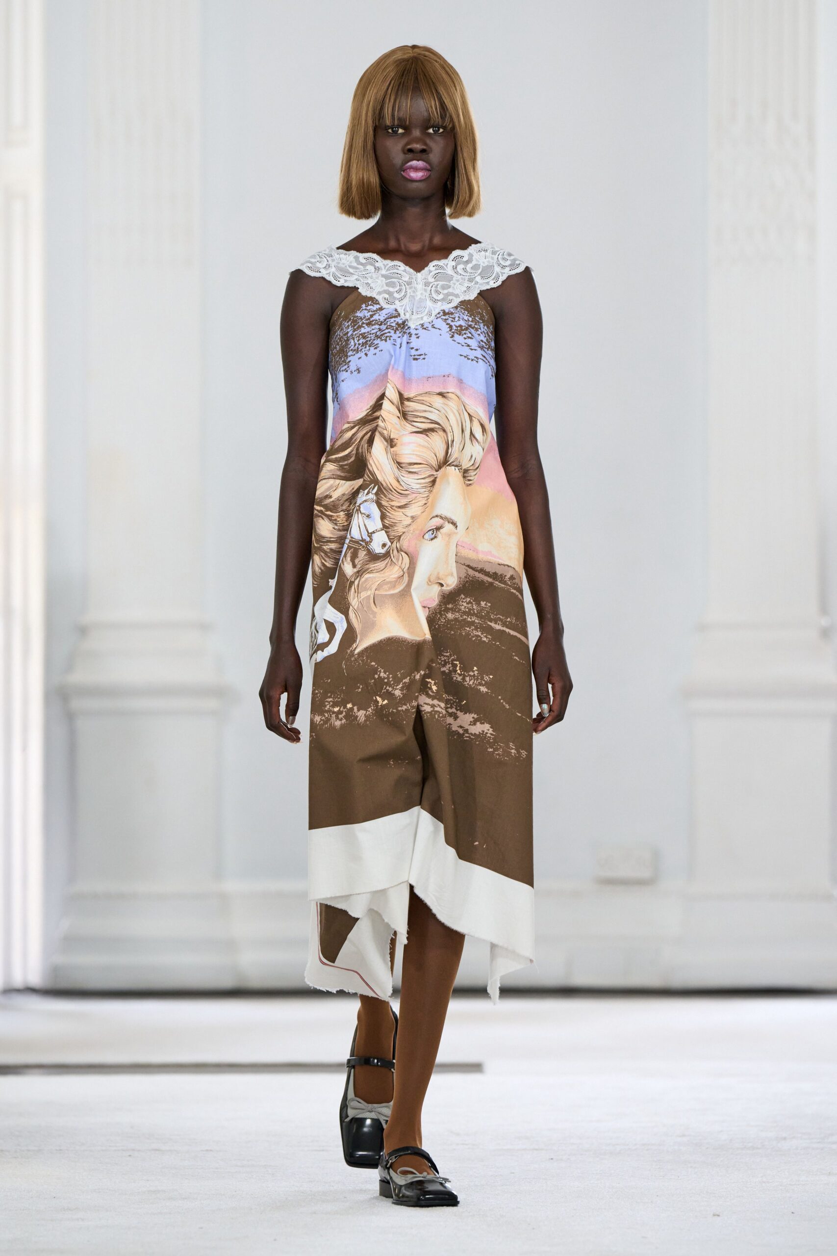 Slip dress printed with a woman's profile, white lace yoke and handkerchief hem. Black square-toe Mary Janes with a pale grey bow across the vamp. Walking the length of a faded seaside hotel before dinner is announced.