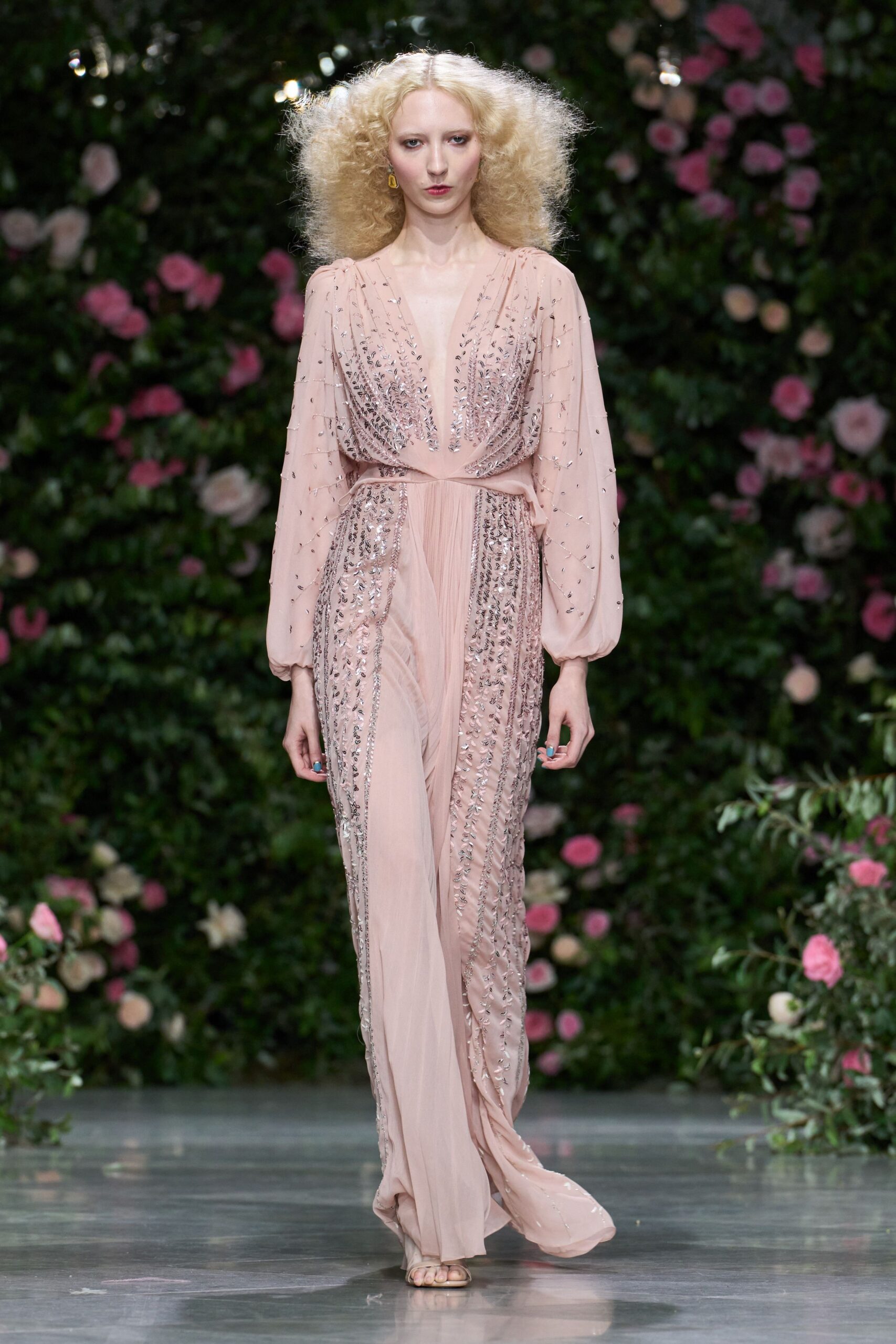 Blush chiffon jumpsuit with a plunging V and silver leaf beading. Billowed sheer sleeves gathered tight at the wrists. Barely there nude sandals. Garden wedding after midnight, petals stuck to the damp flagstones.
