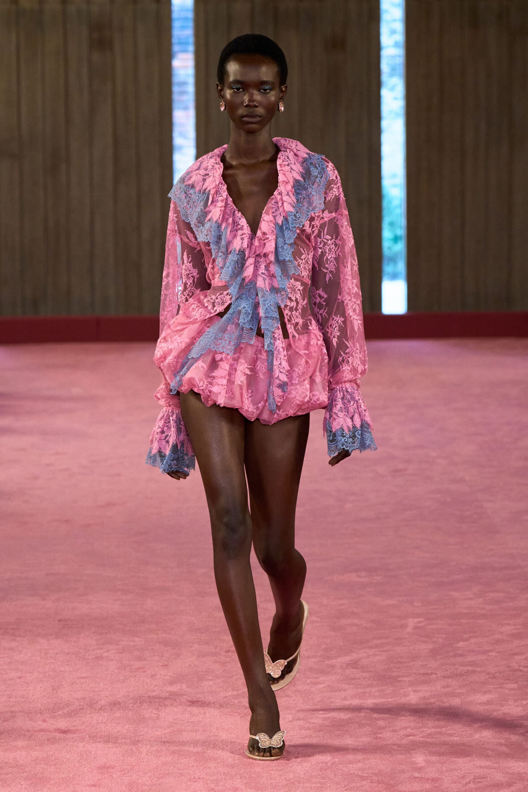 Pink stone drop earrings. Sheer pink floral lace romper with powder-blue lace ruffles and fluted cuffs. Flat thong sandals topped with rhinestone butterfly appliques. Walking barefoot home through a hotel corridor after the wedding brunch.