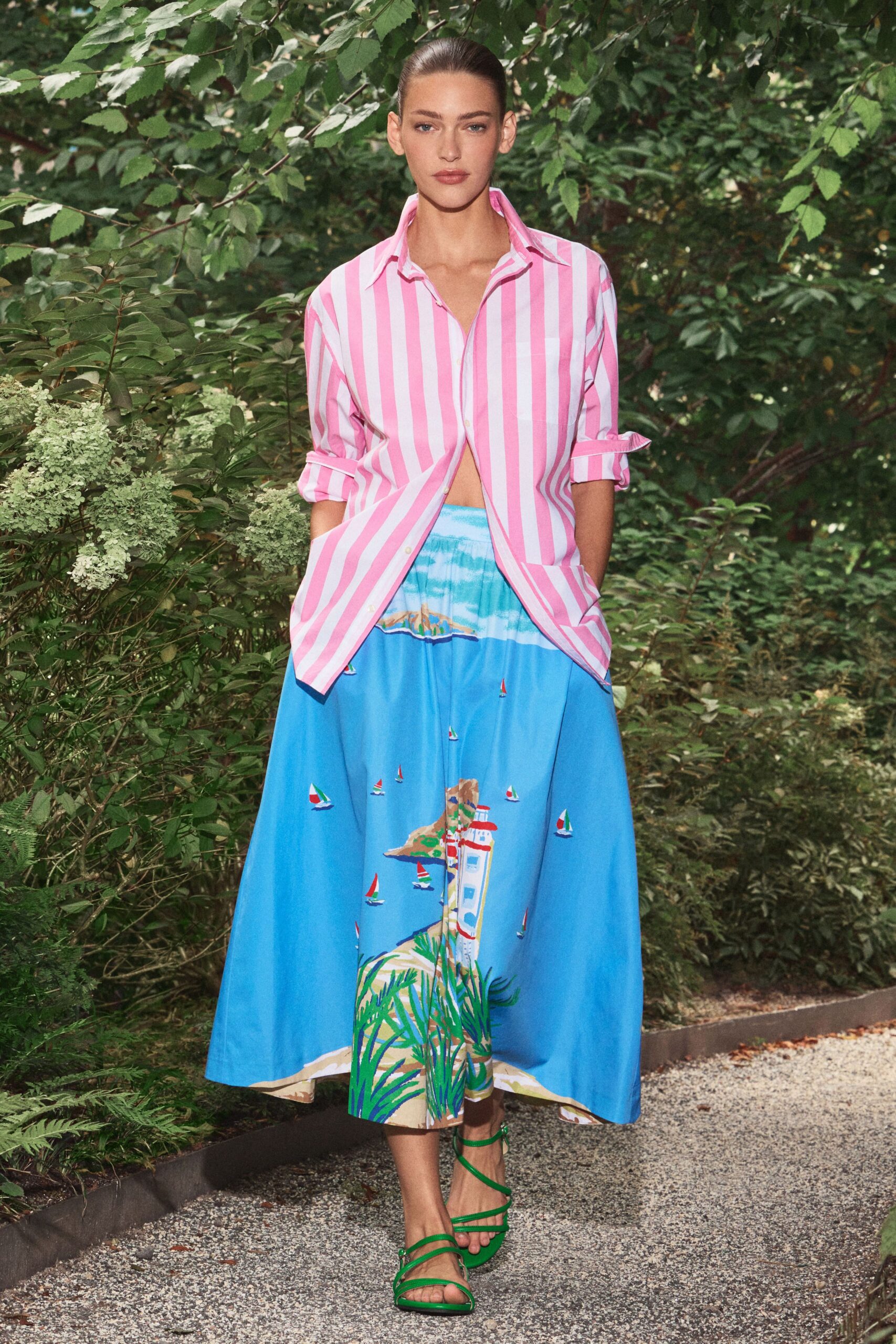 Pink and white striped cotton shirt, sleeves rolled into neat cuffs. Sky-blue full skirt printed with tiny sailboats and a lighthouse. Grass-green strappy sandals wrapping slimly across the foot. Walking the gravel path to a garden lunch by the marina.