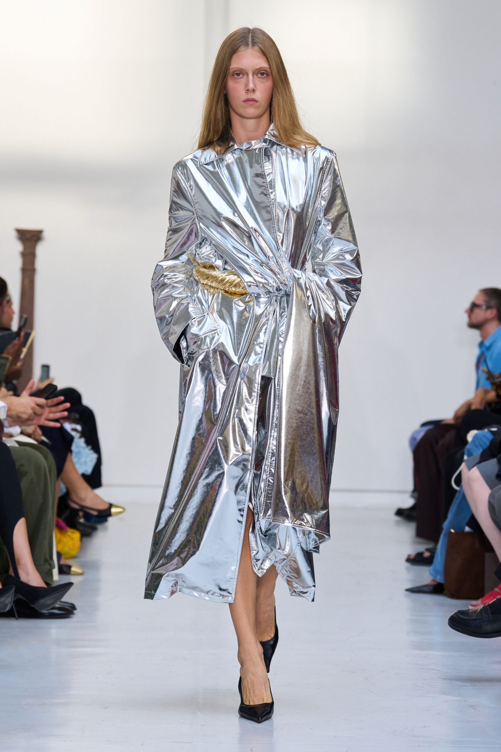 Crinkled silver lamé coat dress, wrapped tight with one gold rope twist at the waist. Black pointed pumps. For crossing a hotel lobby at dawn with yesterday's makeup still on.