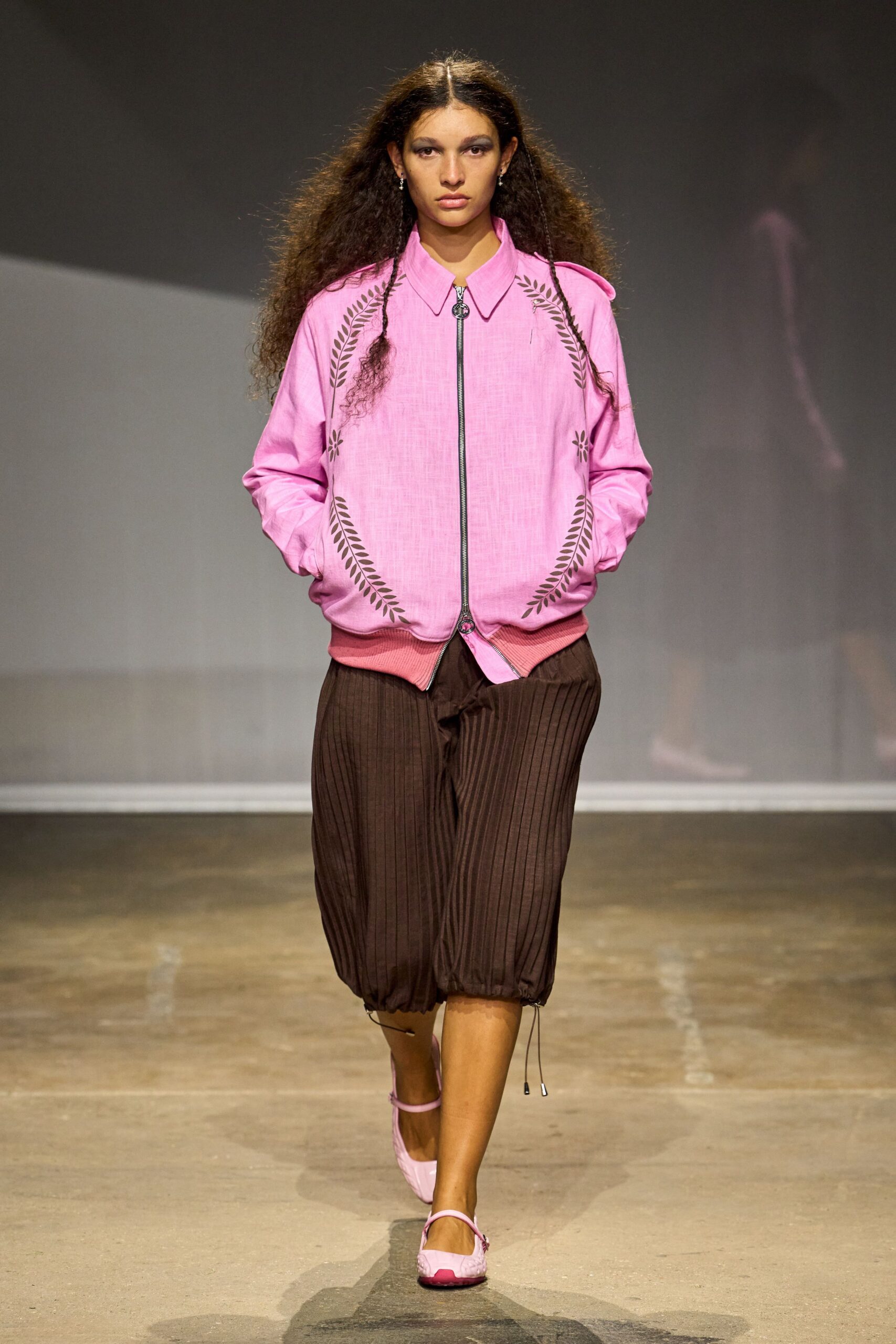 Bubblegum pink linen bomber, brown laurel cutwork framing the zip. Chocolate pinstriped bloomers, drawcord hems grazing the calf. Pale pink Mary Jane flats with a darker pink toe patch. Walking the long way home with bakery paper still warm in your hand.