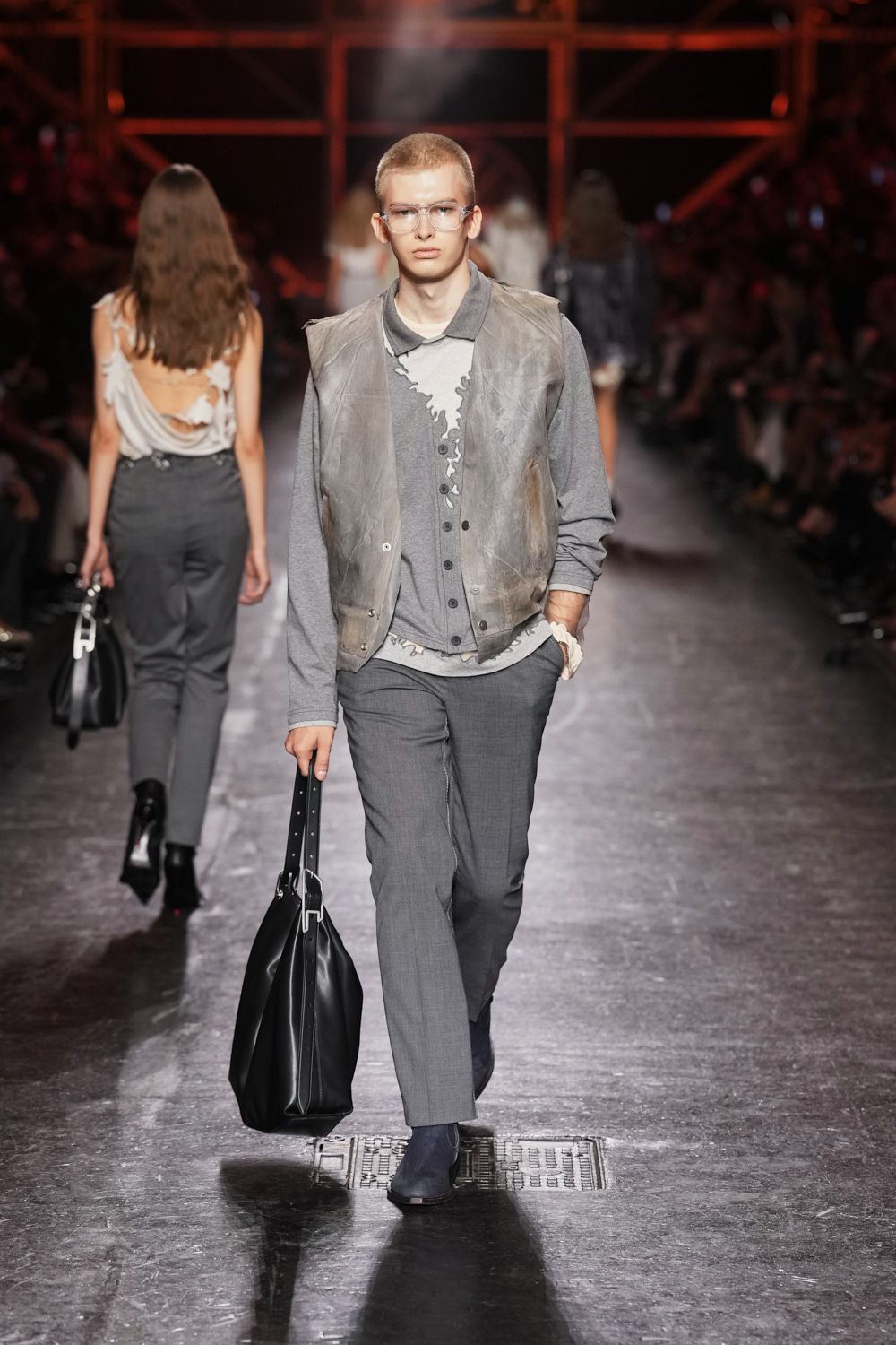 gray leather vest over printed cardigan