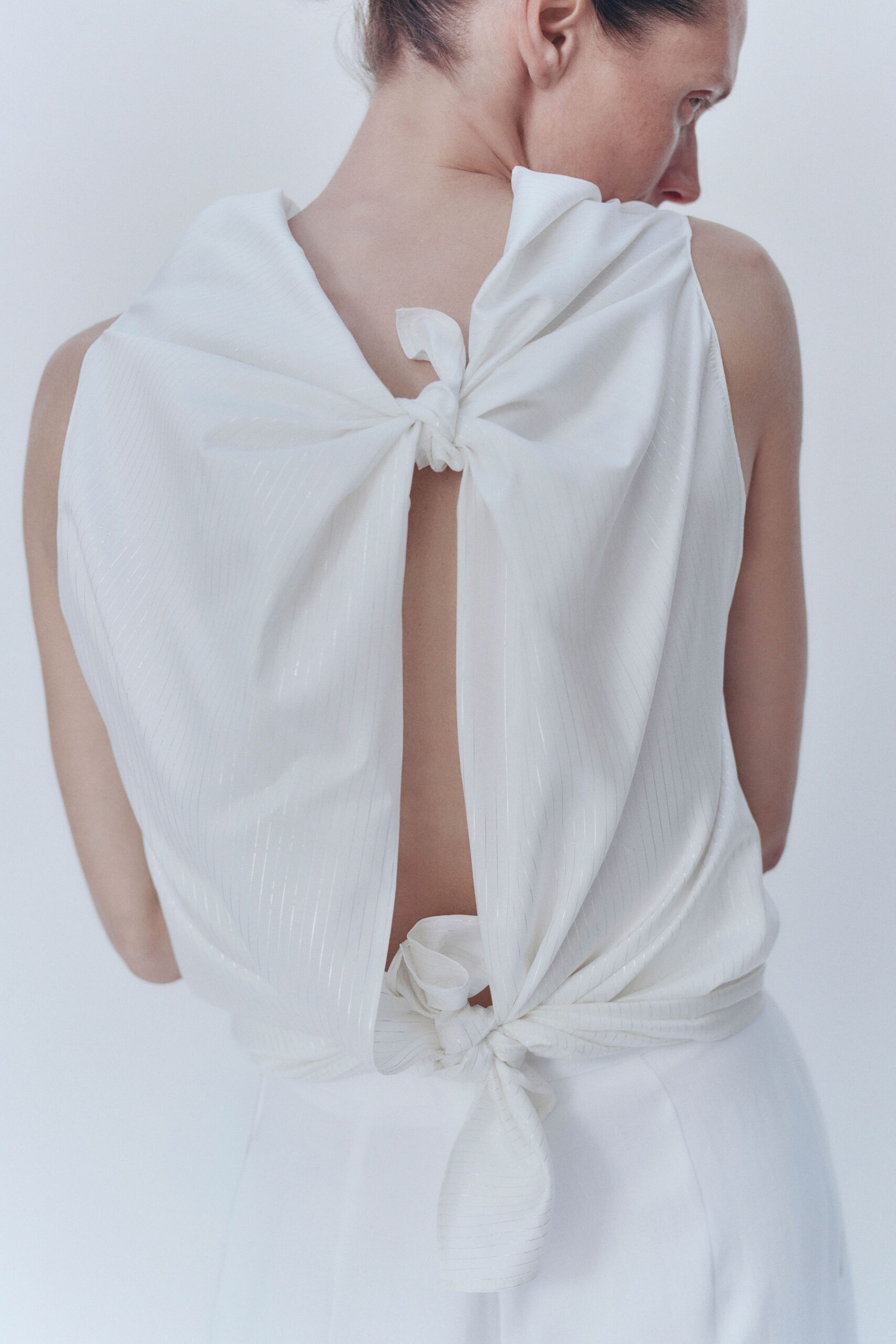white open-back knotted dress