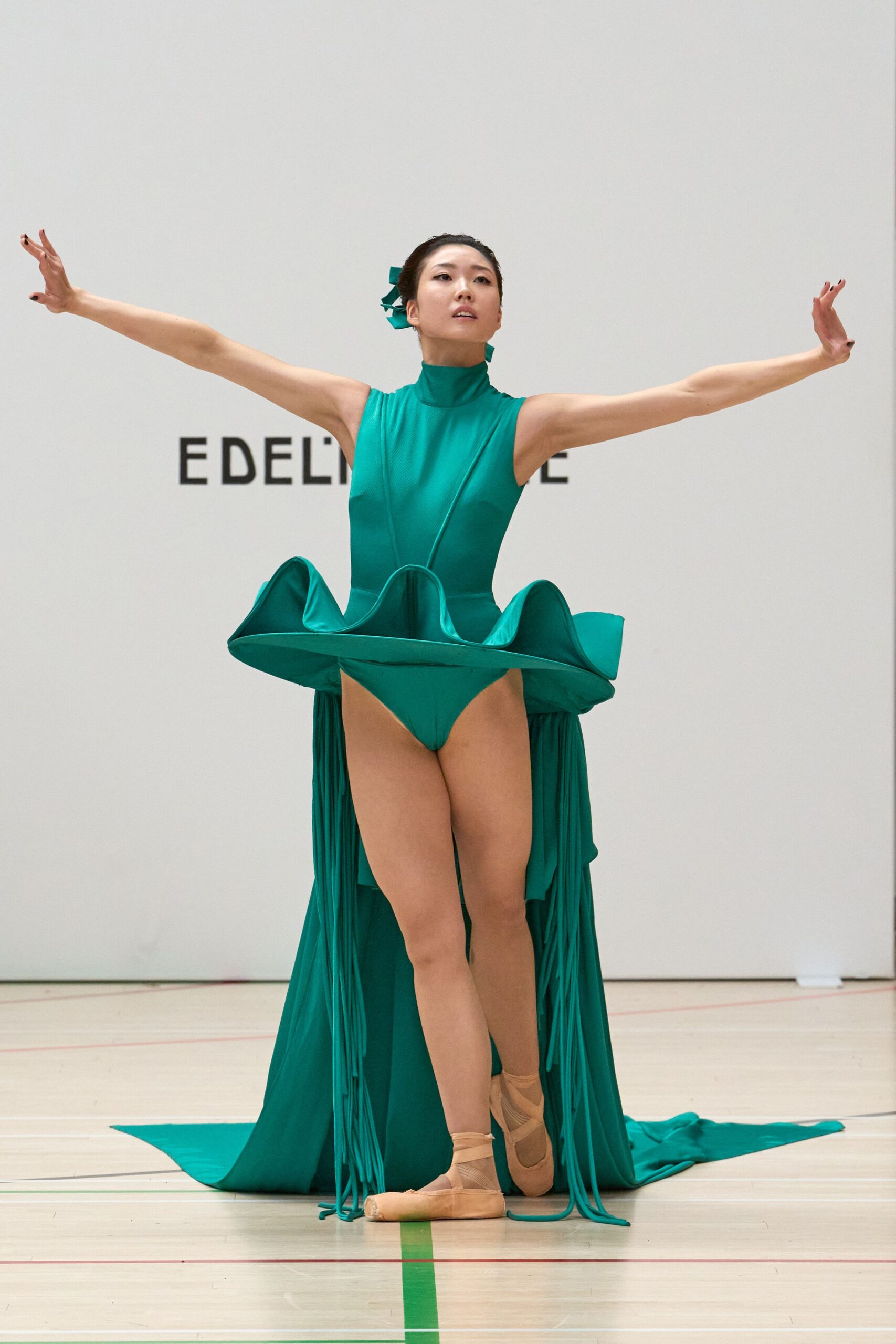 teal sculptural bodysuit with peplum overskirt