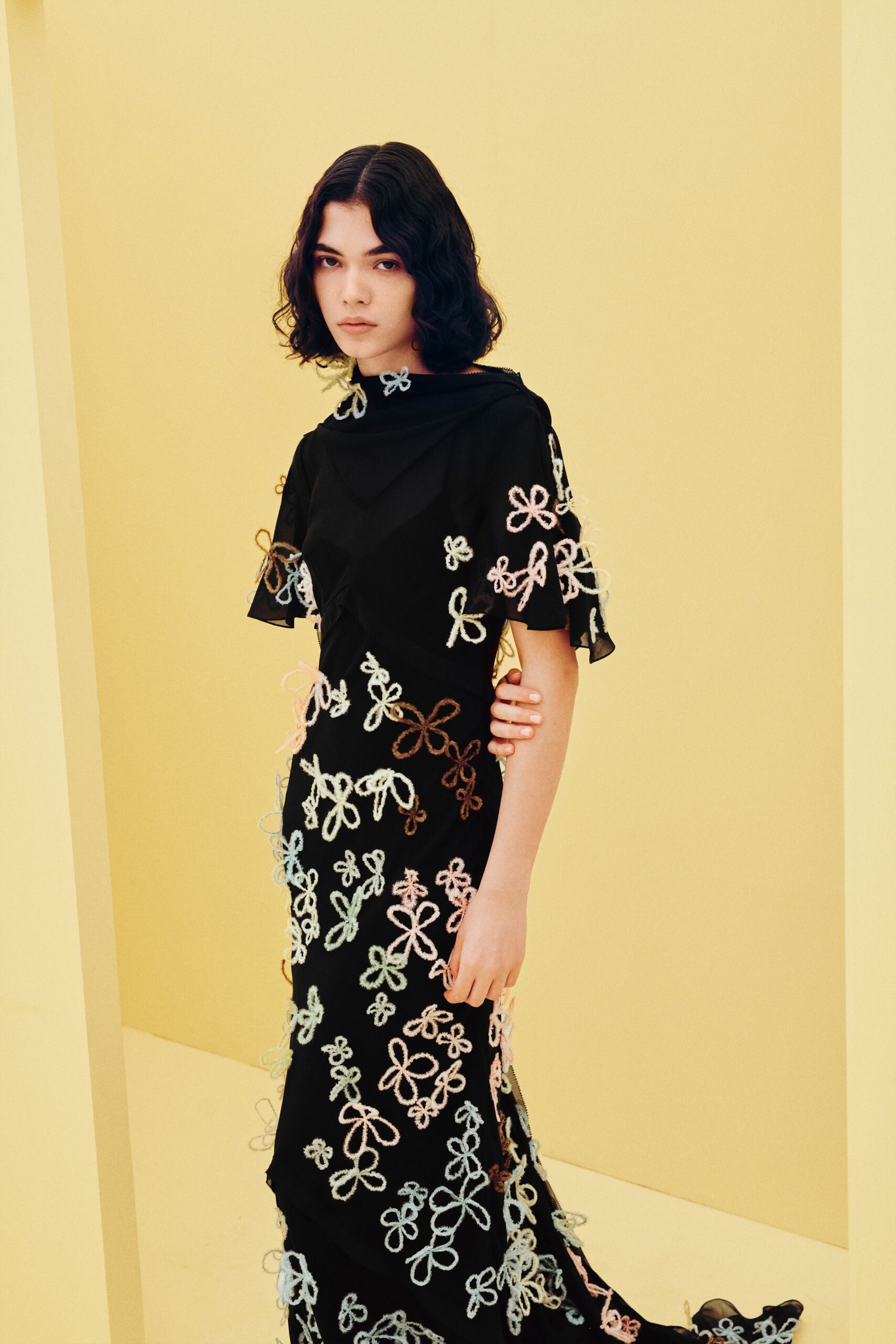 black gown with looped floral appliqué