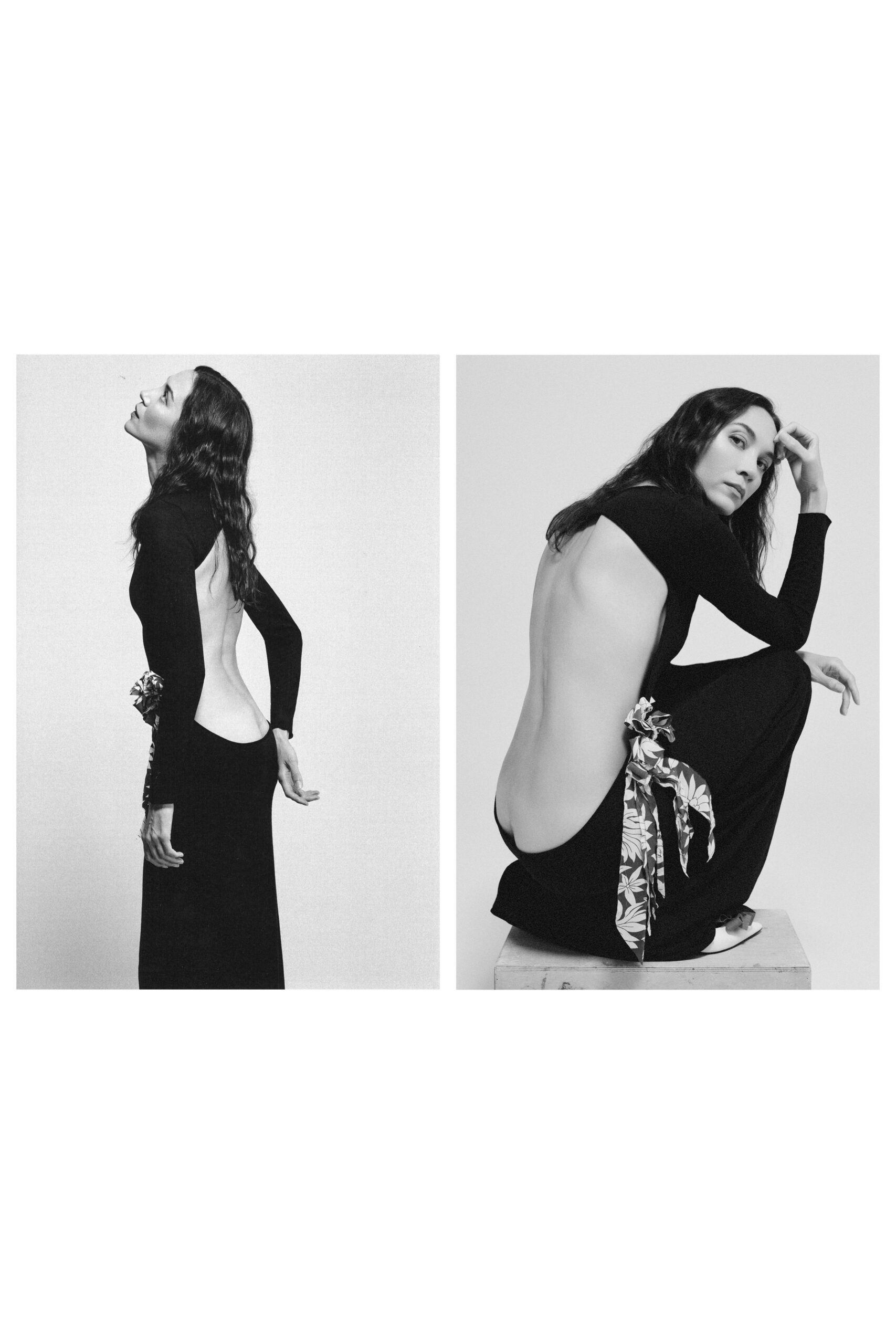 Black jersey column dress with a plunging open back to the hip. Tropical floral sash knotted at the waist, ends hanging loose. White thong sandals, barely there. Sitting on a cool windowsill after the hotel party emptied out.