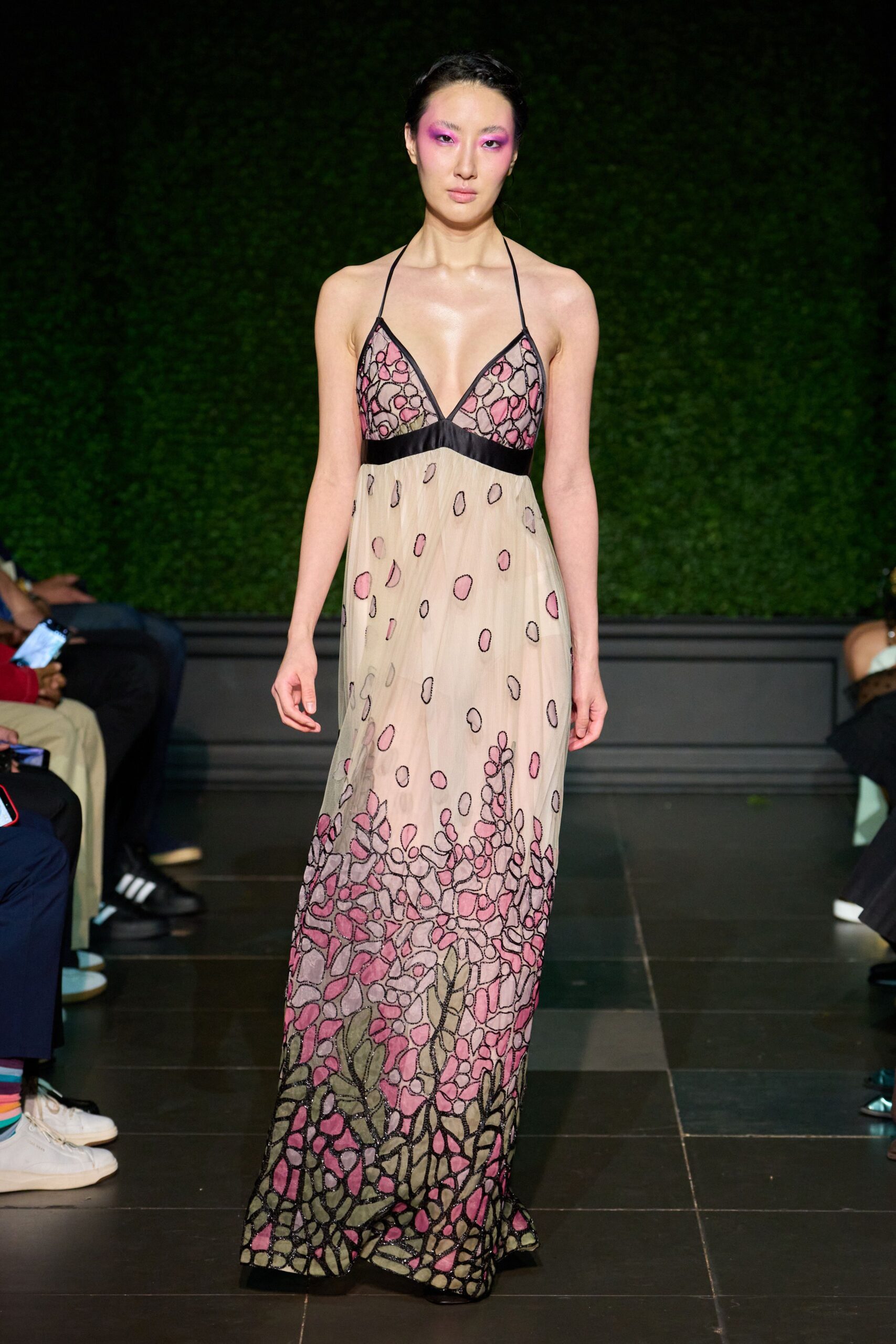 Sheer blush halter gown with black binding and pebble-like pink appliqué thickening at the hem. Garden party after midnight, the grass still wet through your sandals.