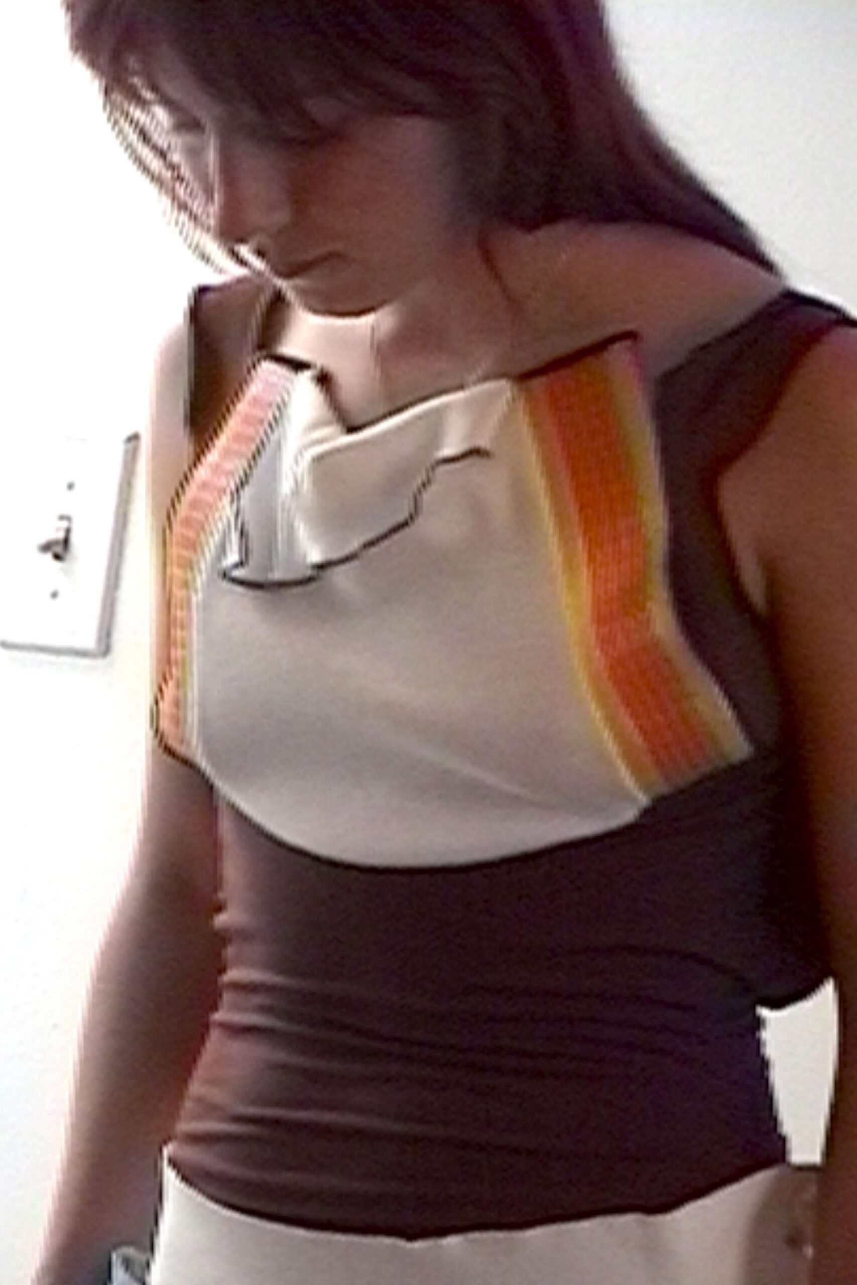 Cream and chocolate knit dress with sunset side stripes and a curved flap seam at the bust. Afternoon in a beach motel corridor, still damp from the pool.