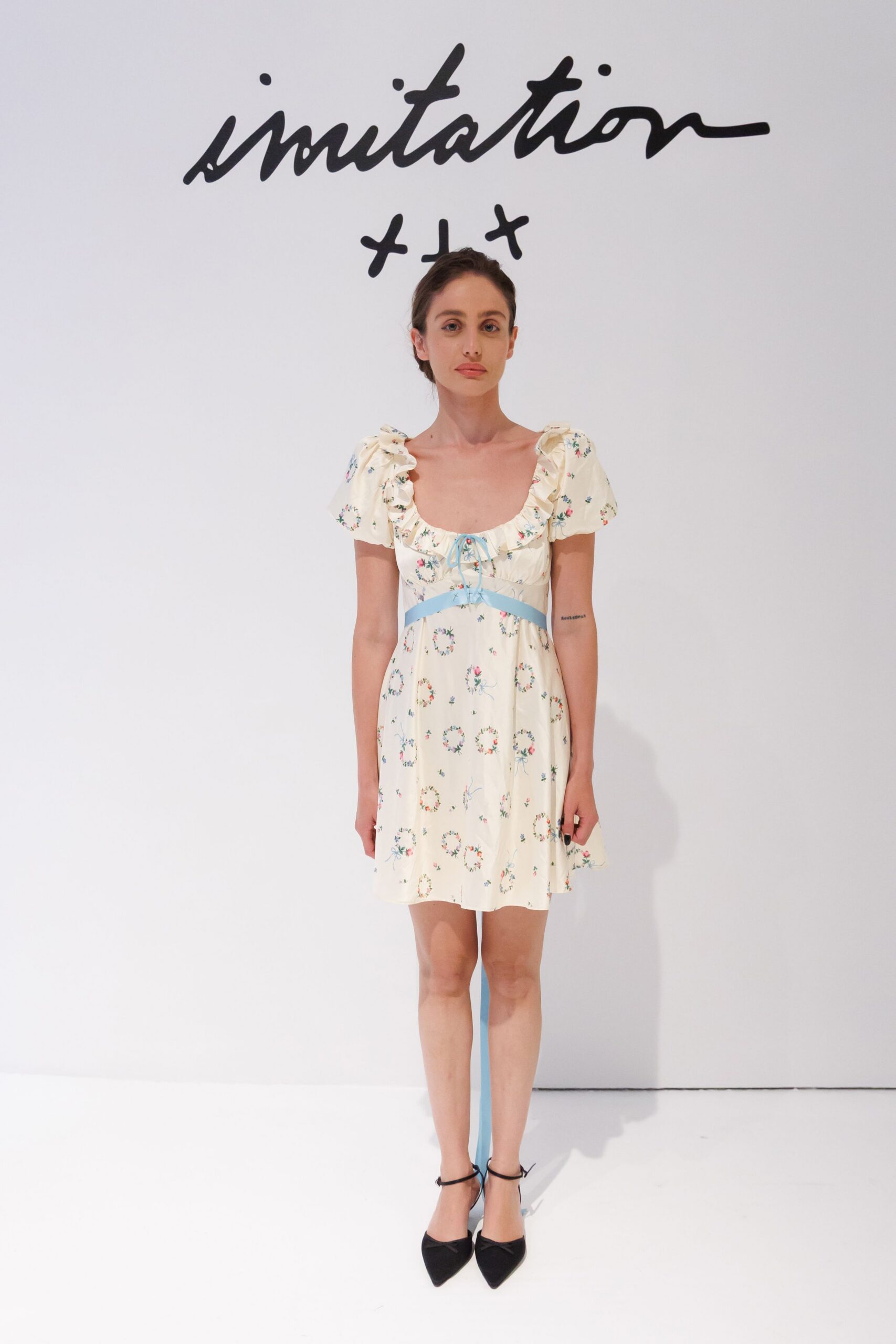 Cream floral dress with ruffled scoop neckline and sky-blue ribbon underbust. Black pointed pumps with slim ankle ties. For picking strawberries badly, then buying jam instead.