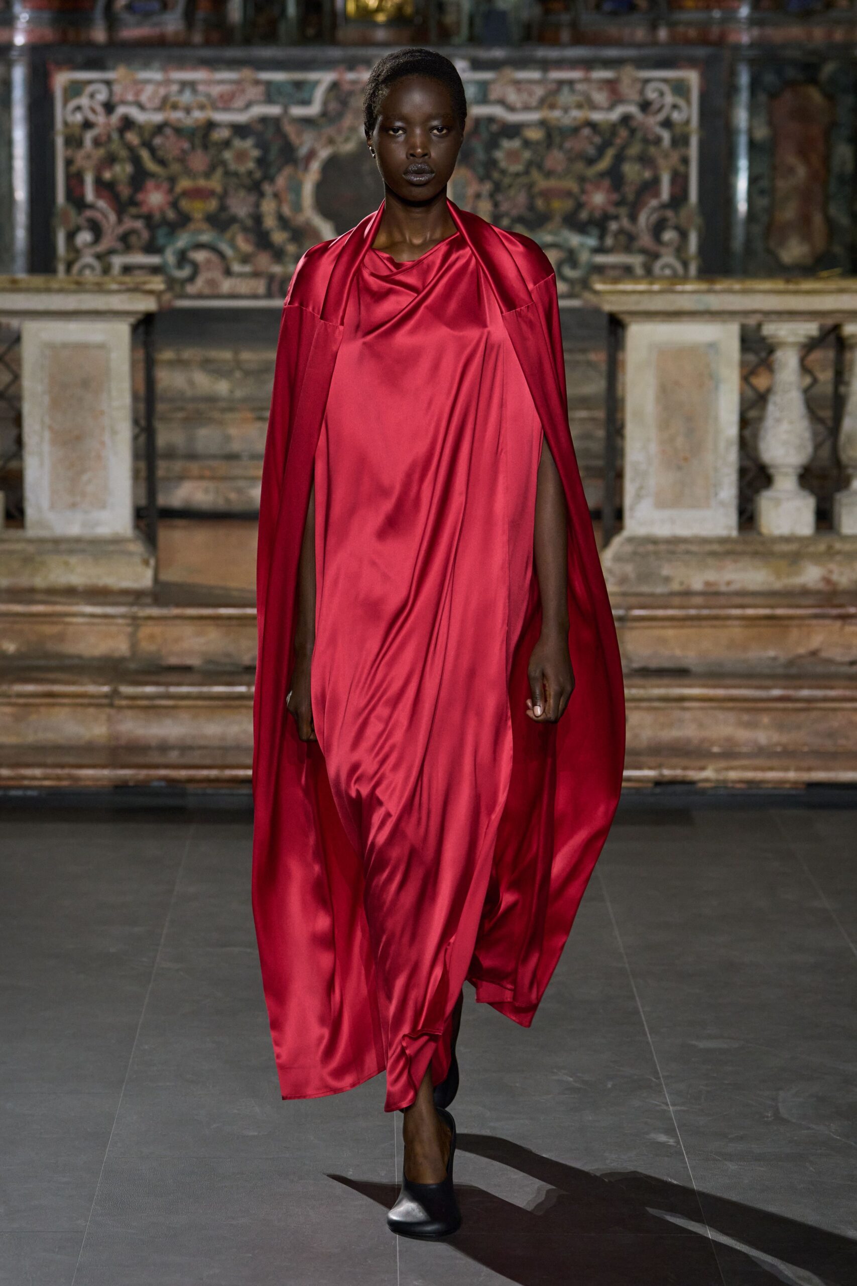 red satin draped cape gown