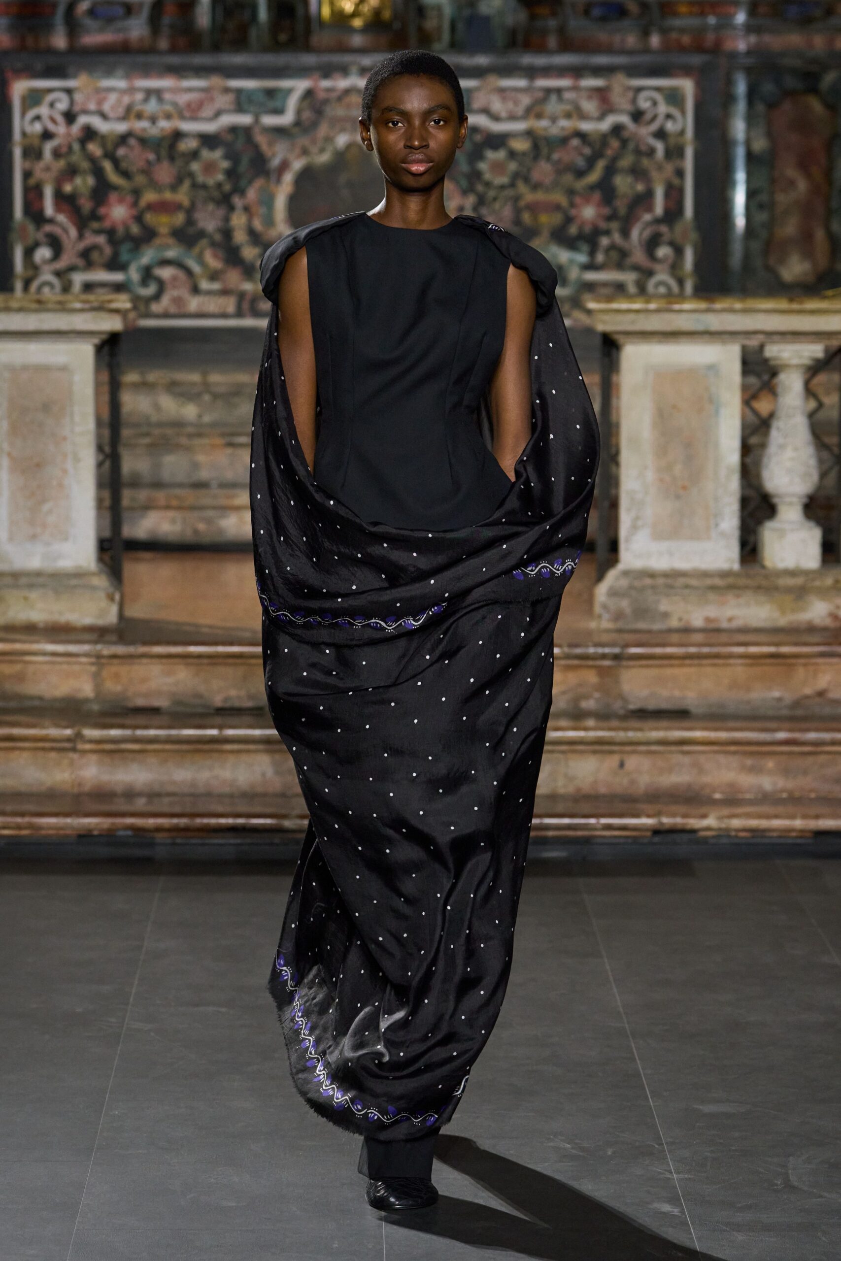 black polka-dot scarf-draped evening gown