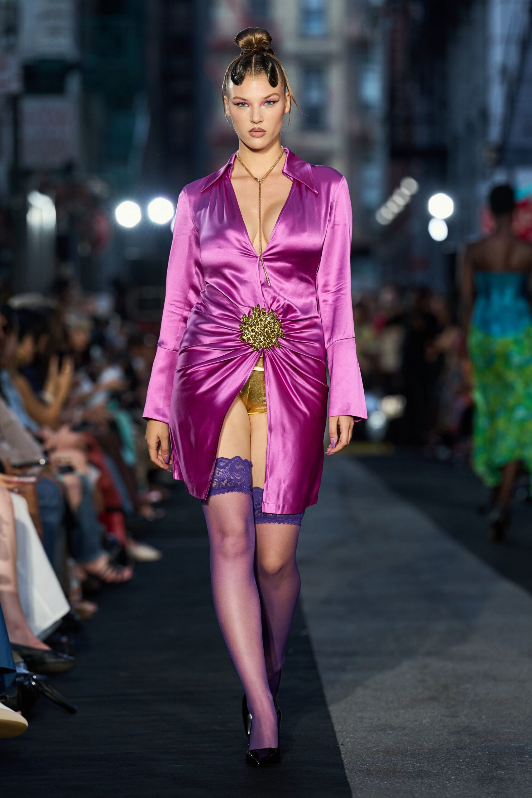 Fuchsia satin shirt dress ruched hard into a spiky gold medallion. Fine lariat chain dropping into the plunging V. Metallic gold shorts flashing through the front slit. Sheer violet thigh-highs with a wide lace stay. Black patent pumps. Whatever you wear home after dancing till the street sweepers start.