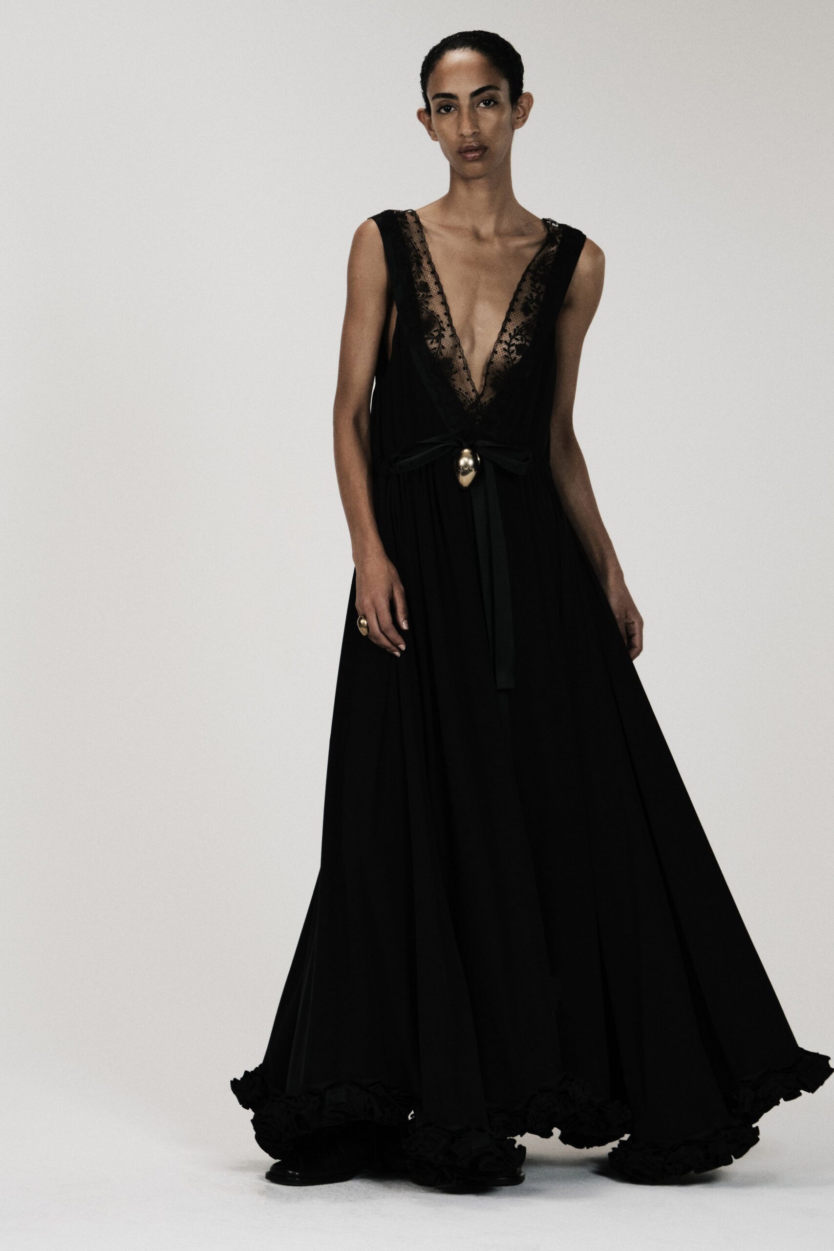black chiffon sleeveless low-cut belted ruffled gown