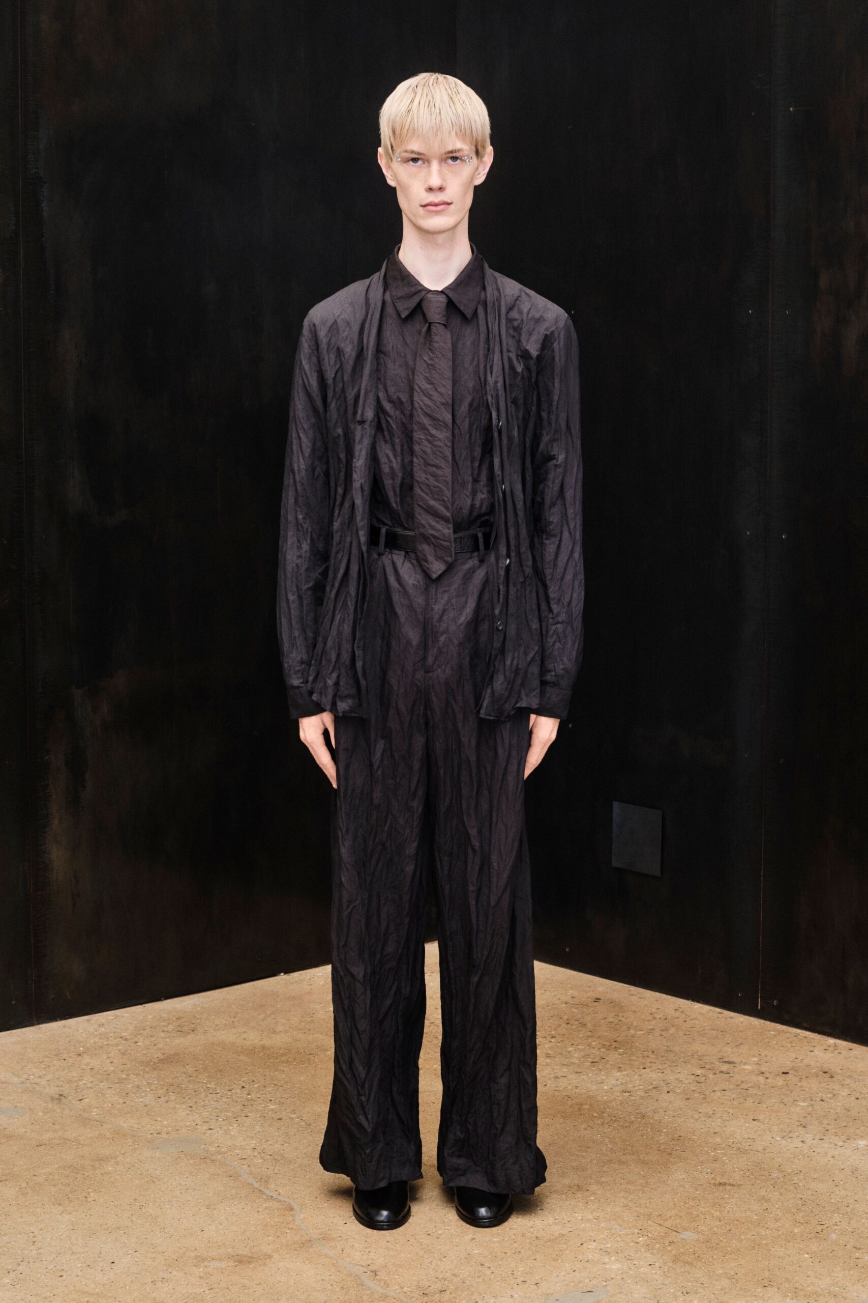crinkled black shirt and wide-leg trousers