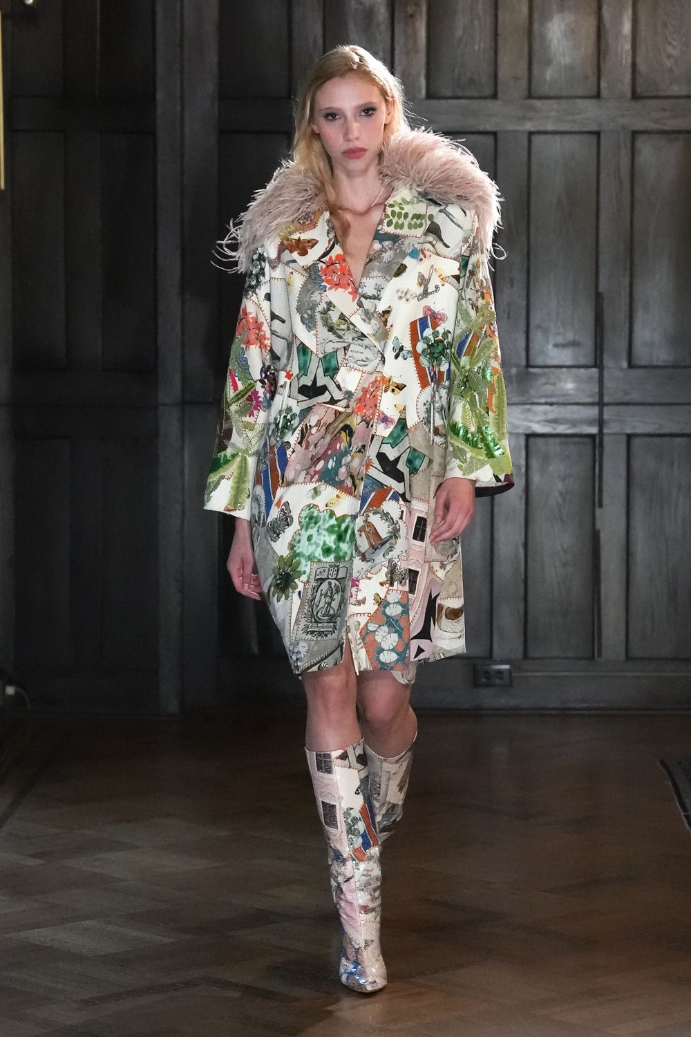 Cream coatdress in collage print, shawl collar buried under pale ostrich feathers. Matching knee boots in the same postcard print, silvered toe caps catching light. Crossing a drafty manor hallway after raiding the stationery drawer.