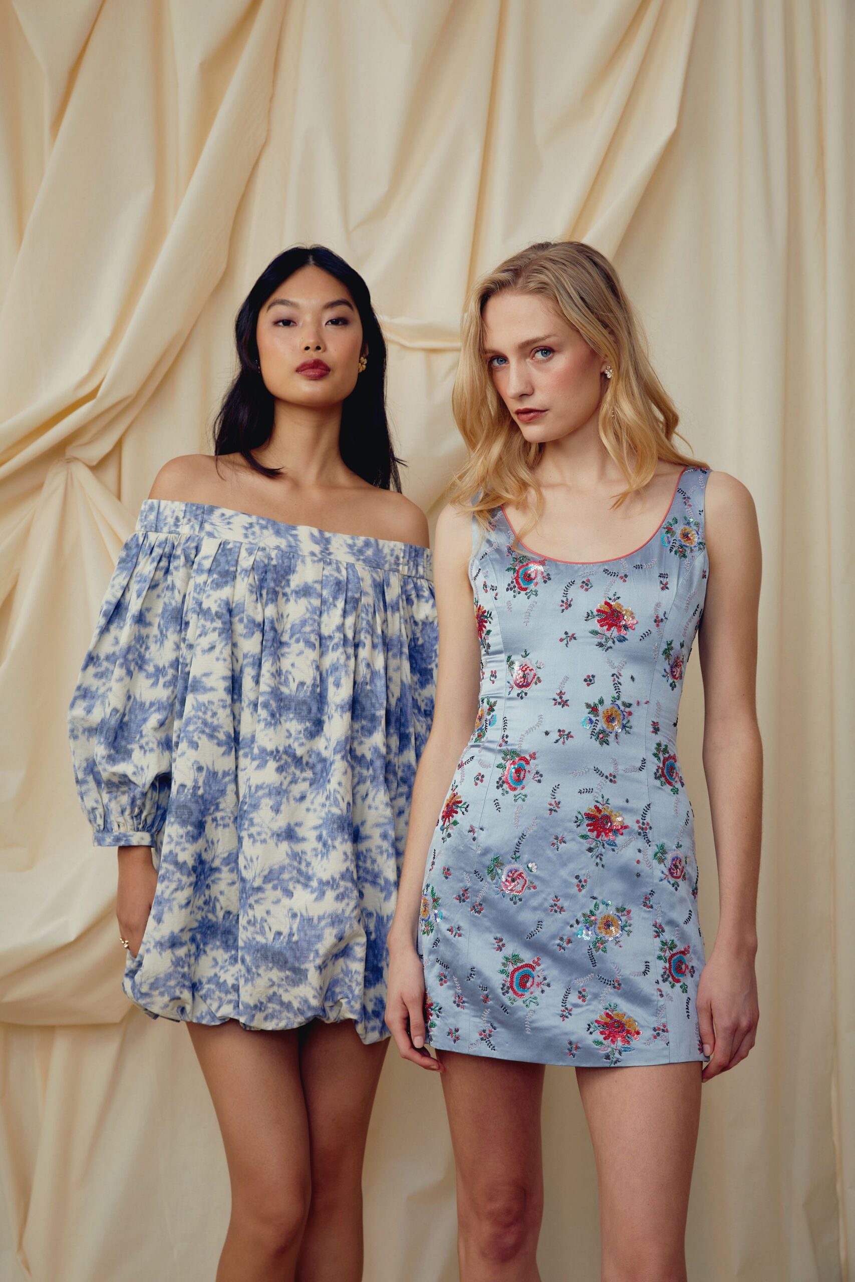 Powder-blue satin slip dress scattered with dense multicolour floral embroidery. Small crystal flower studs at both ears. Garden wedding brunch after the cake has started to melt.