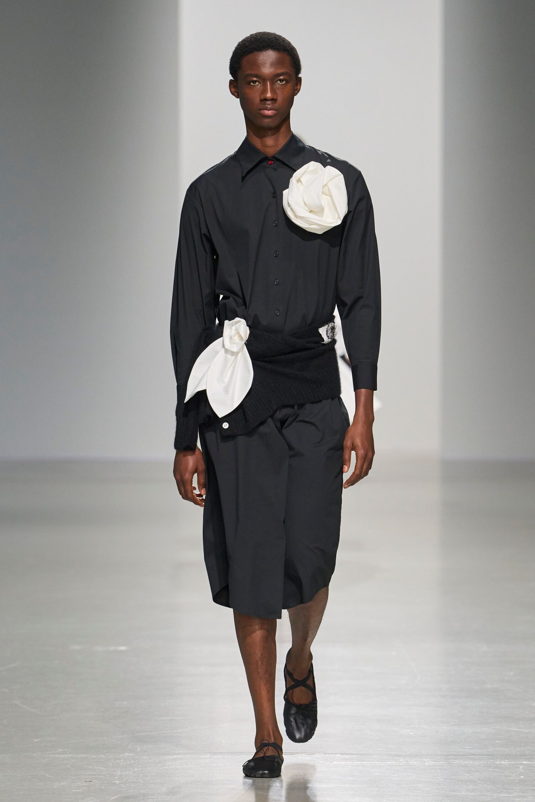 black shirt with oversized floral appliqués