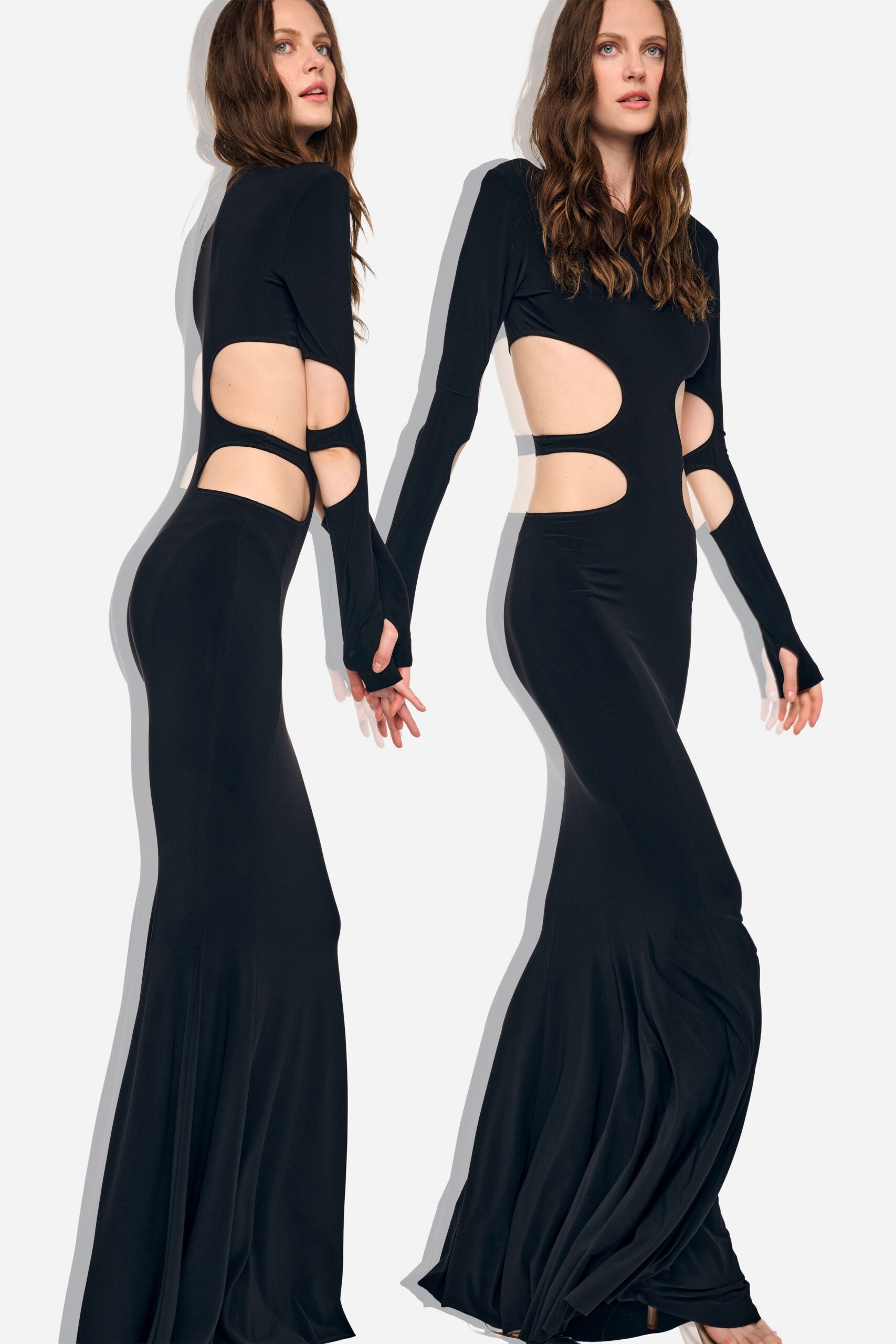 Black stretch jersey gown with oval waist cutouts and thumbhole sleeves. Barely there heels, hidden under the pooling hem. Whatever you wear home when the party moved to the hotel roof.