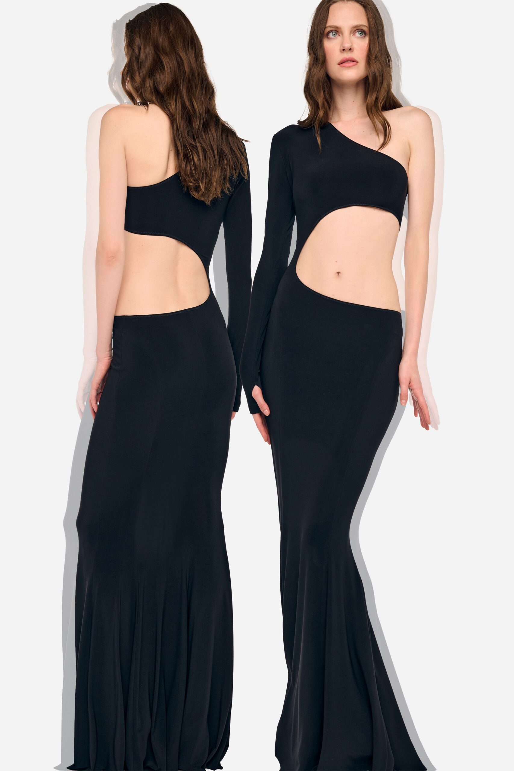 Black jersey one-sleeve gown with a bare shoulder and sweeping waist cutout. For the hotel ballroom wedding where someone slips out to the terrace alone.