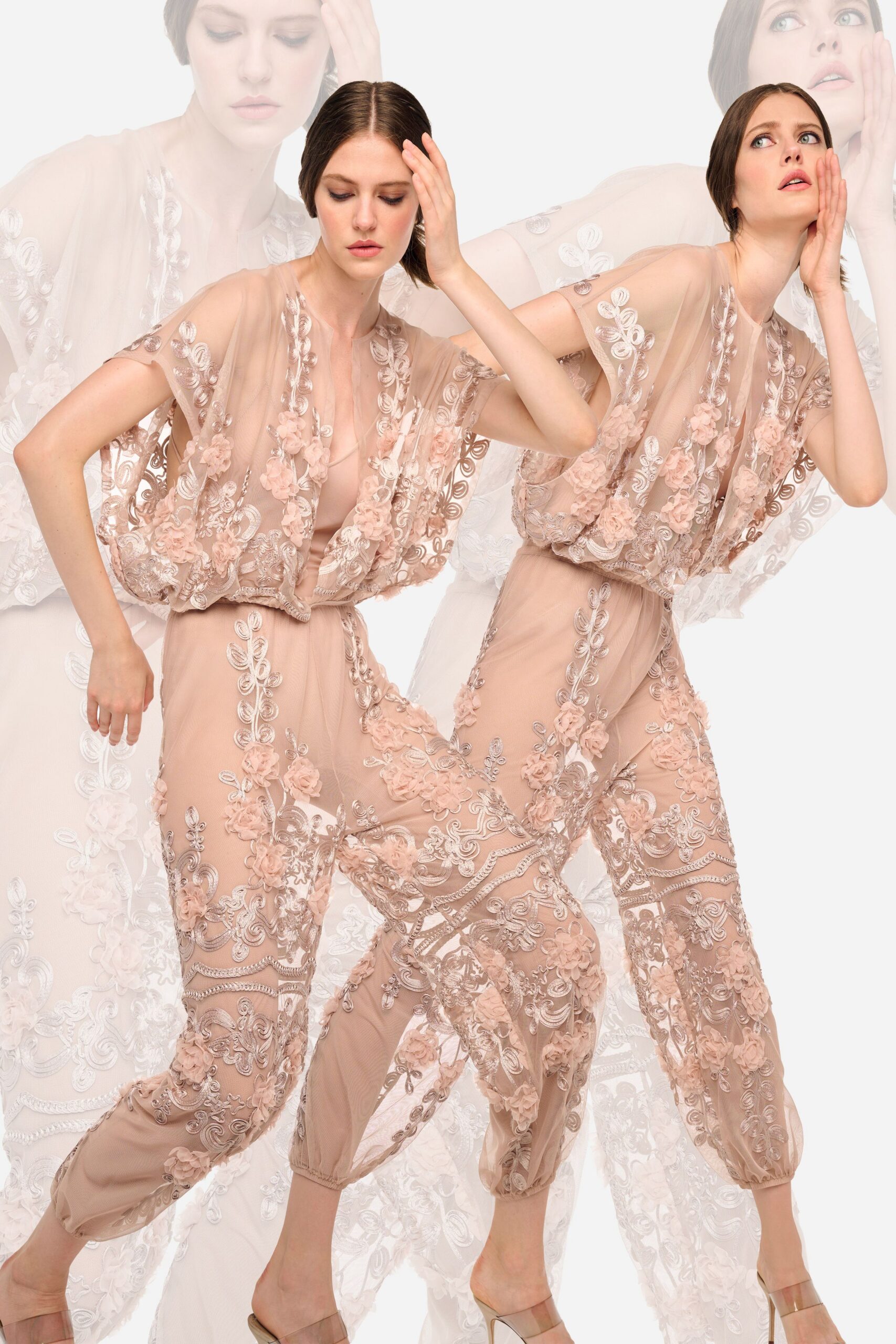 Blush illusion tulle jumpsuit, silver soutache and appliqued rosettes climbing over plunge and sleeves. Clear vinyl strap mules with mirrored stiletto heels. Walking across a hotel ballroom before the chairs are set.