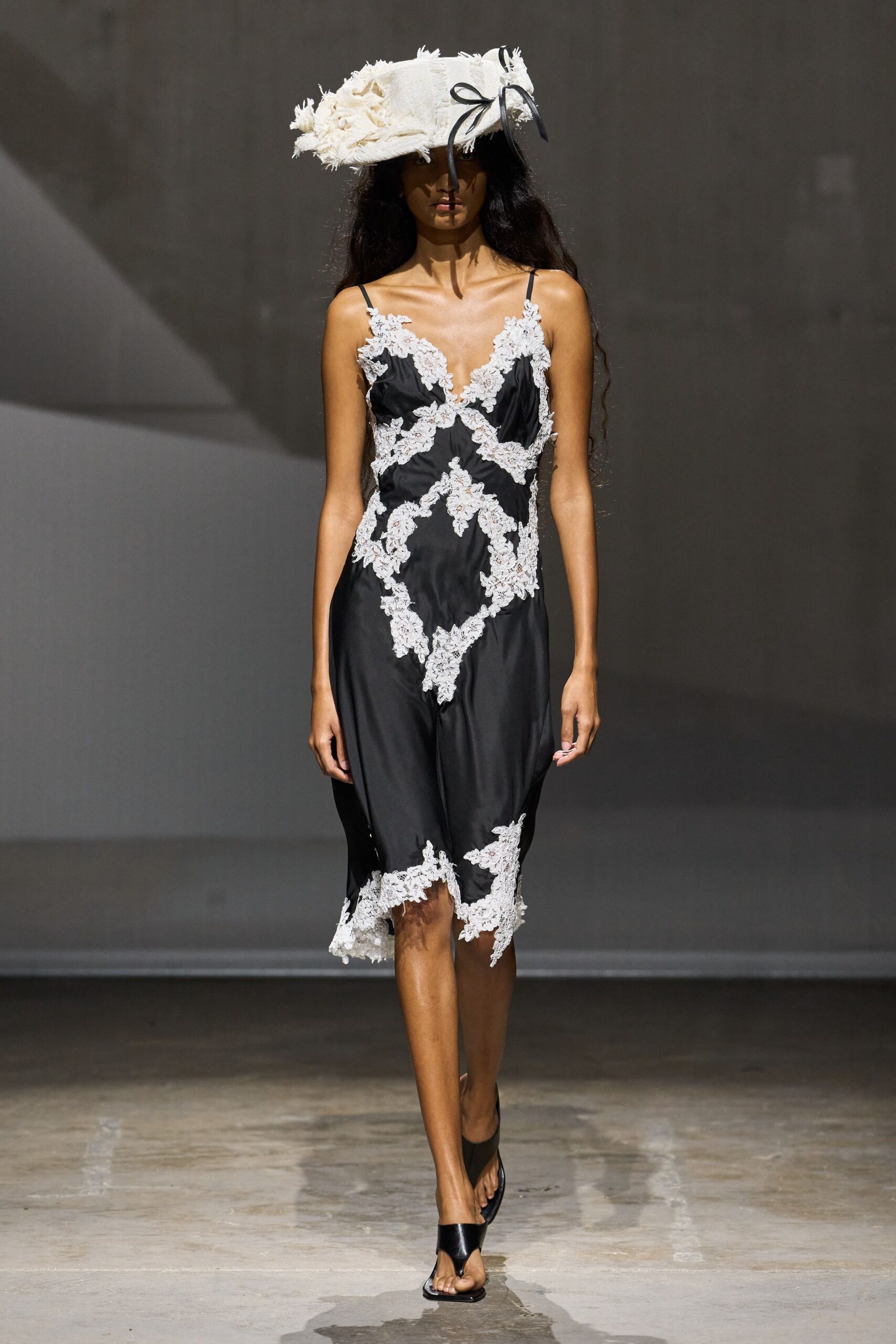 black slip dress with white lace appliqué