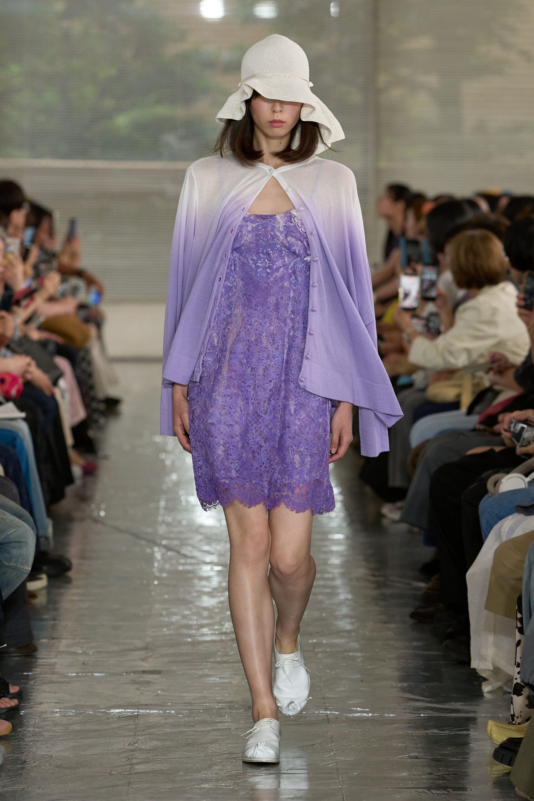 White woven cloche hat with a floppy brim, lilac cardigan fading from chalk to violet with tiny covered buttons, lavender lace slip dress with a scalloped hem, white lace-up flats. Waiting for the ferry in sea haze.
