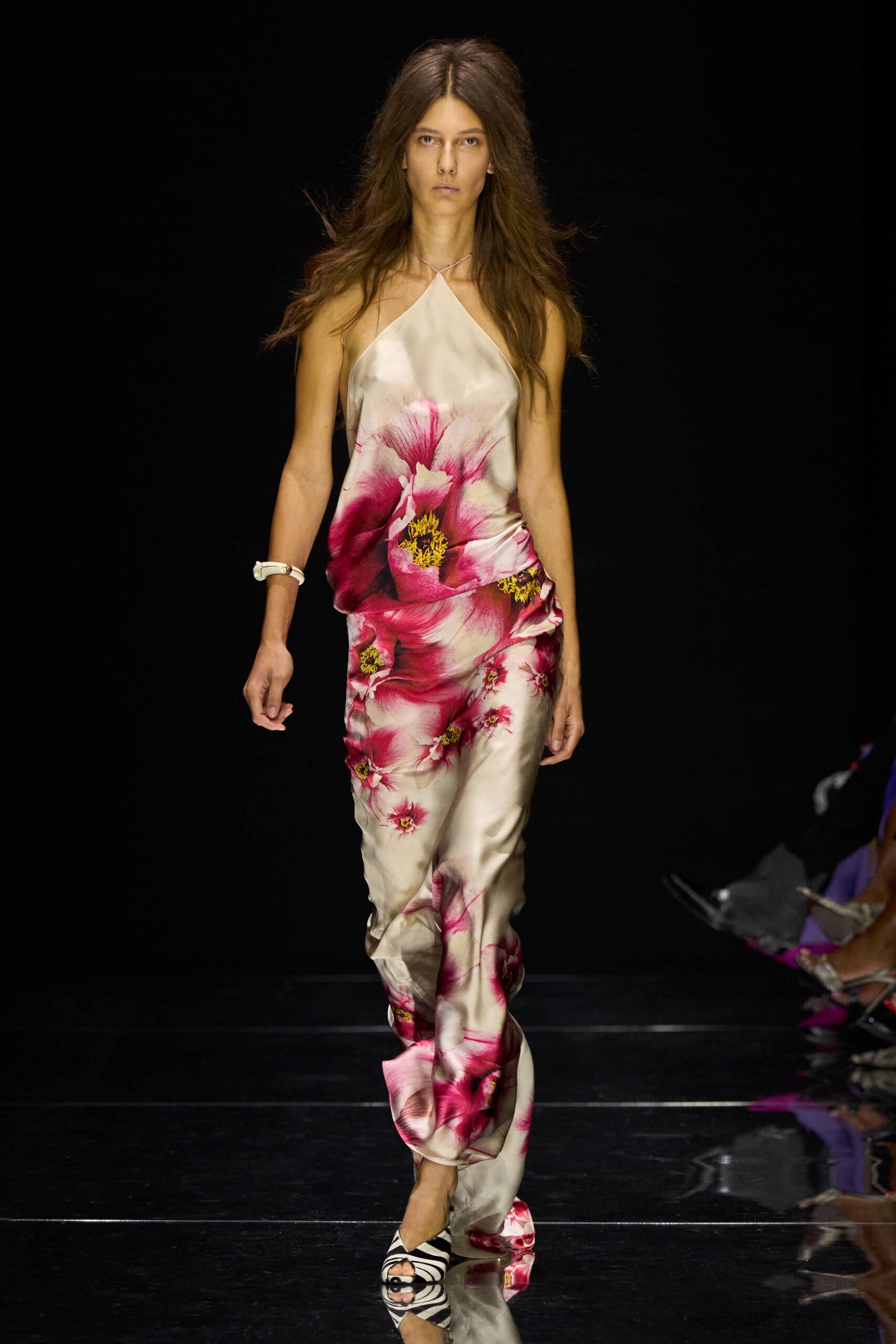 Ivory satin halter top washed with oversized peony petals. Matching satin trousers, slouched and caught in a twist at the ankle. Chunky white bangle at one wrist. Zebra-striped peep-toe mules. Leaving a hotel wedding barefoot-minded, flowers already bruising in the heat.