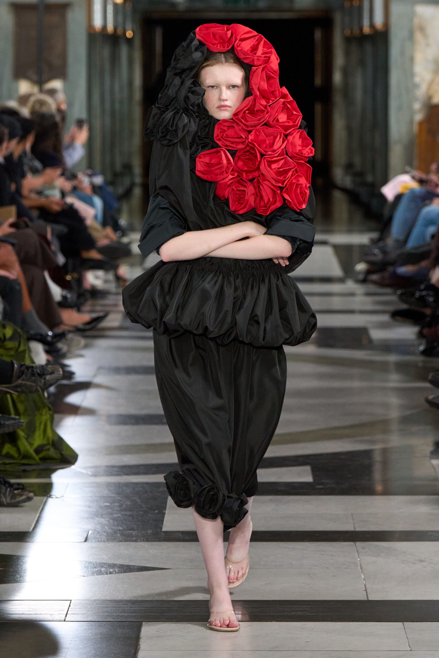 black gown with oversized red rosettes