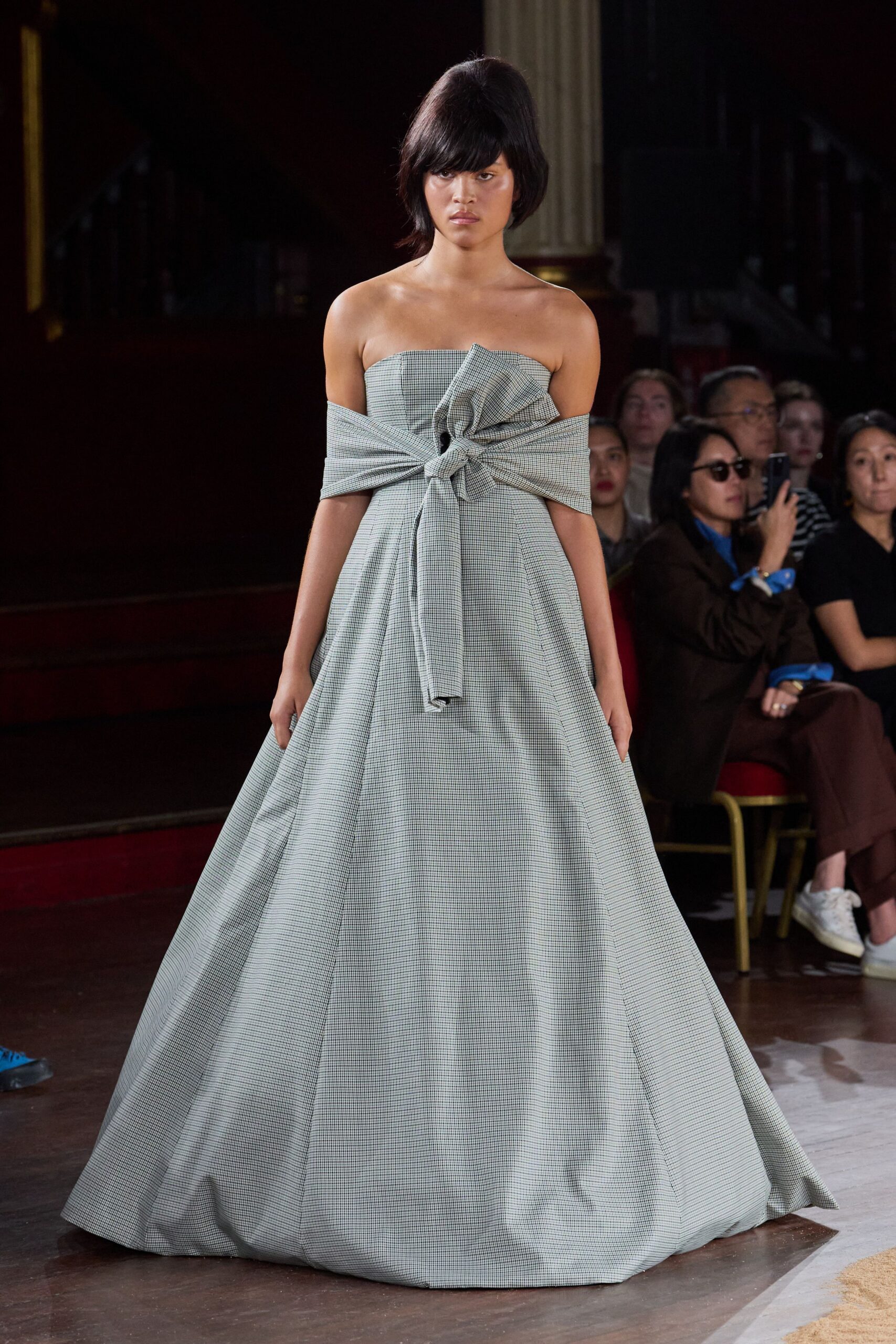 Strapless micro-check ballgown with a wide off-shoulder sash knotted at the bust. For entering a drafty civic hall after everyone else is already seated.